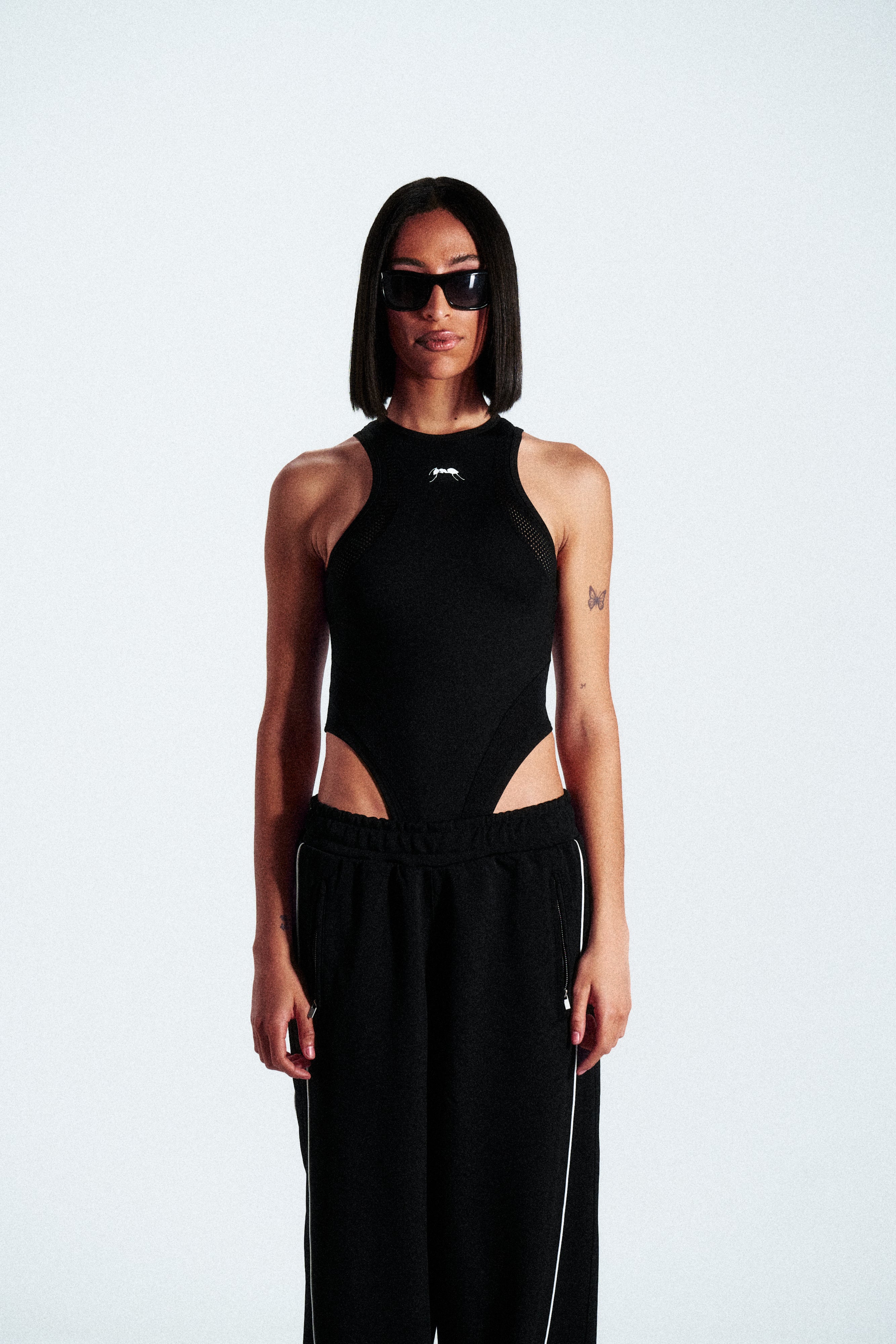 Sleeveless shaping bodysuit made from stretch technical fabric. Available in black. Worldwide shipping.