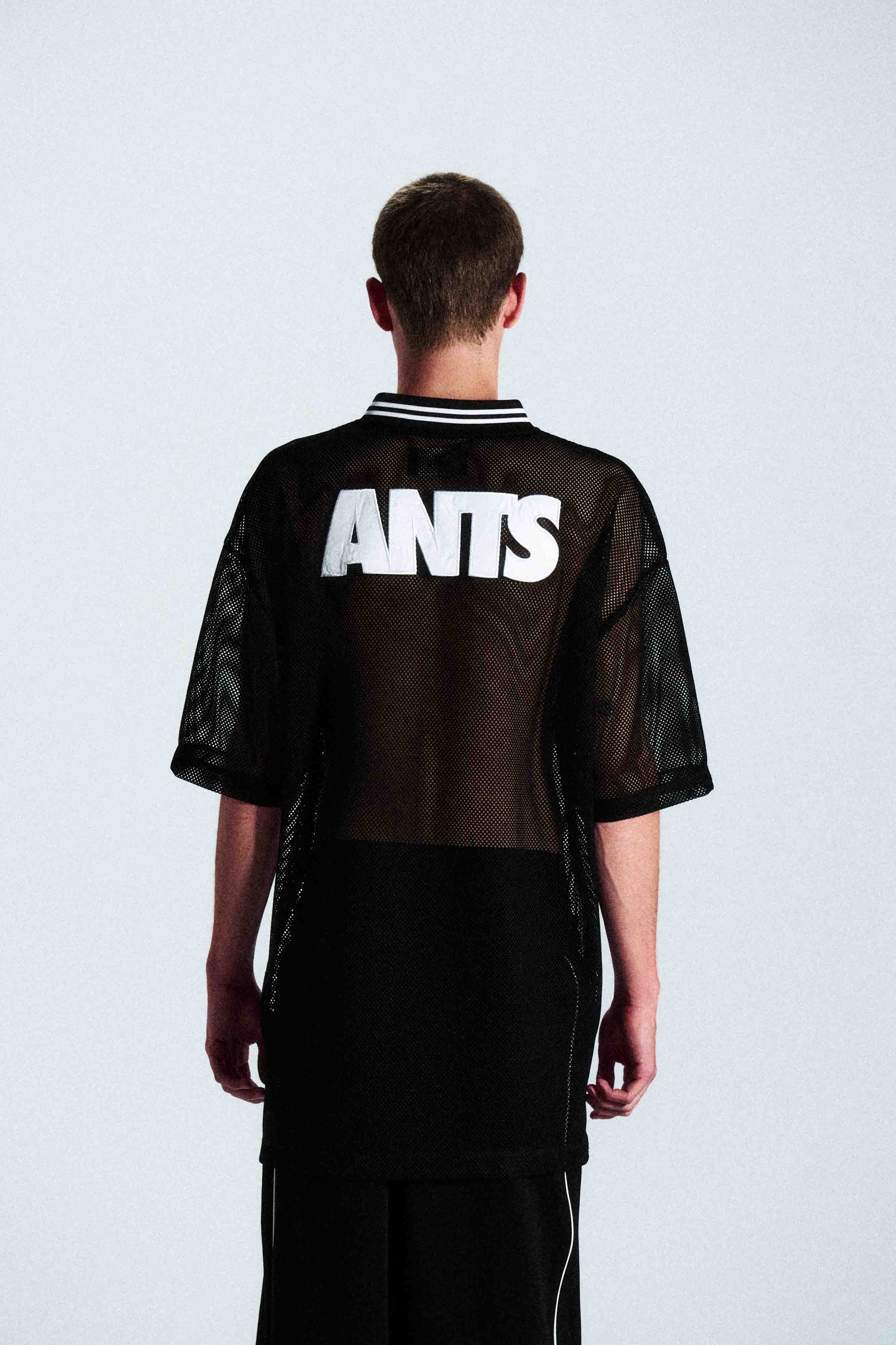 Short-sleeve sports jersey made of 100% polyester mesh. Lightweight, breathable, and quick-drying. White ANTS logos on front and back. Straight cut with comfortable fit.