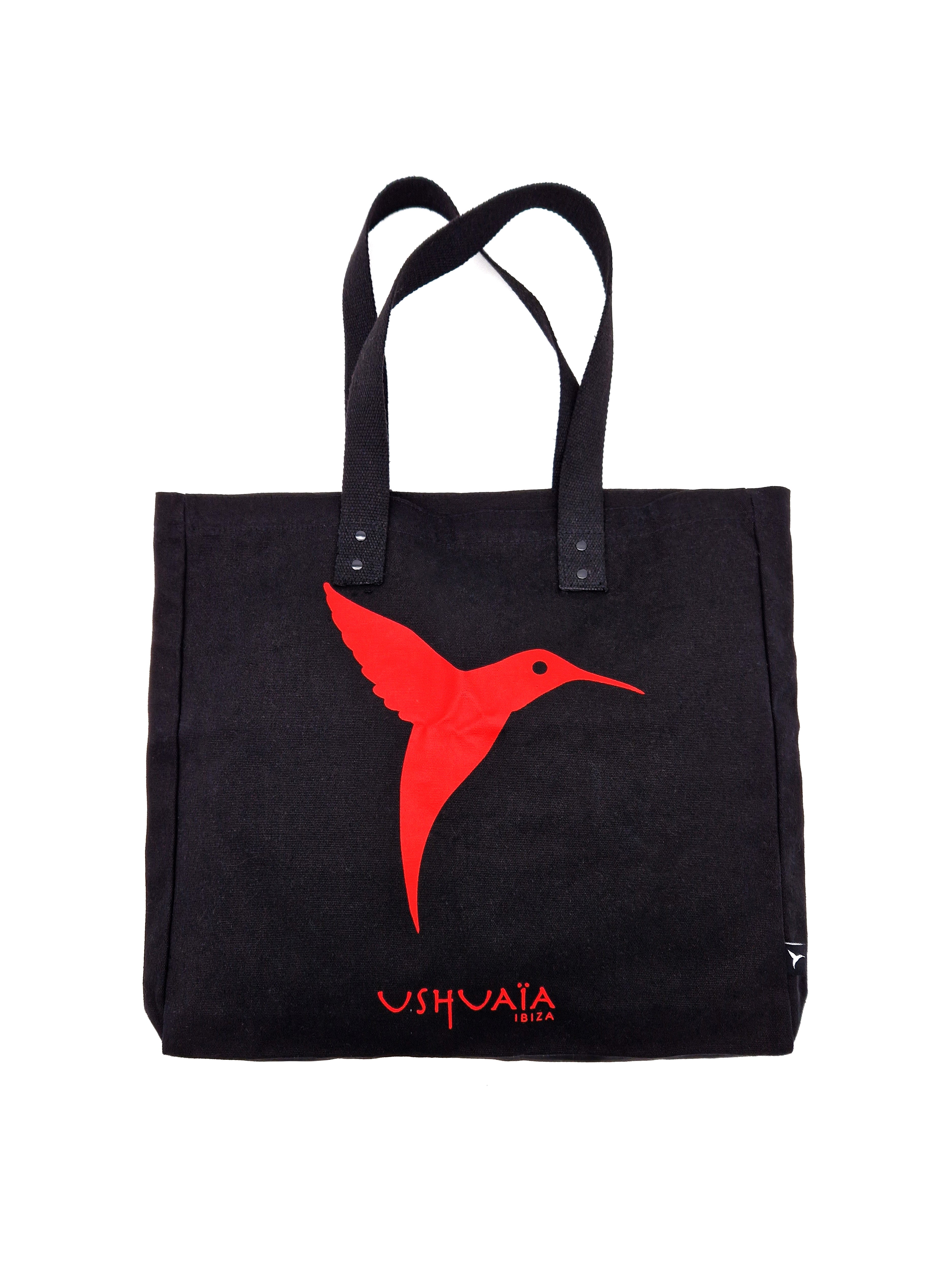 Black Ushuaïa Ibiza shopping bag featuring a contrasting hummingbird logo print on the front