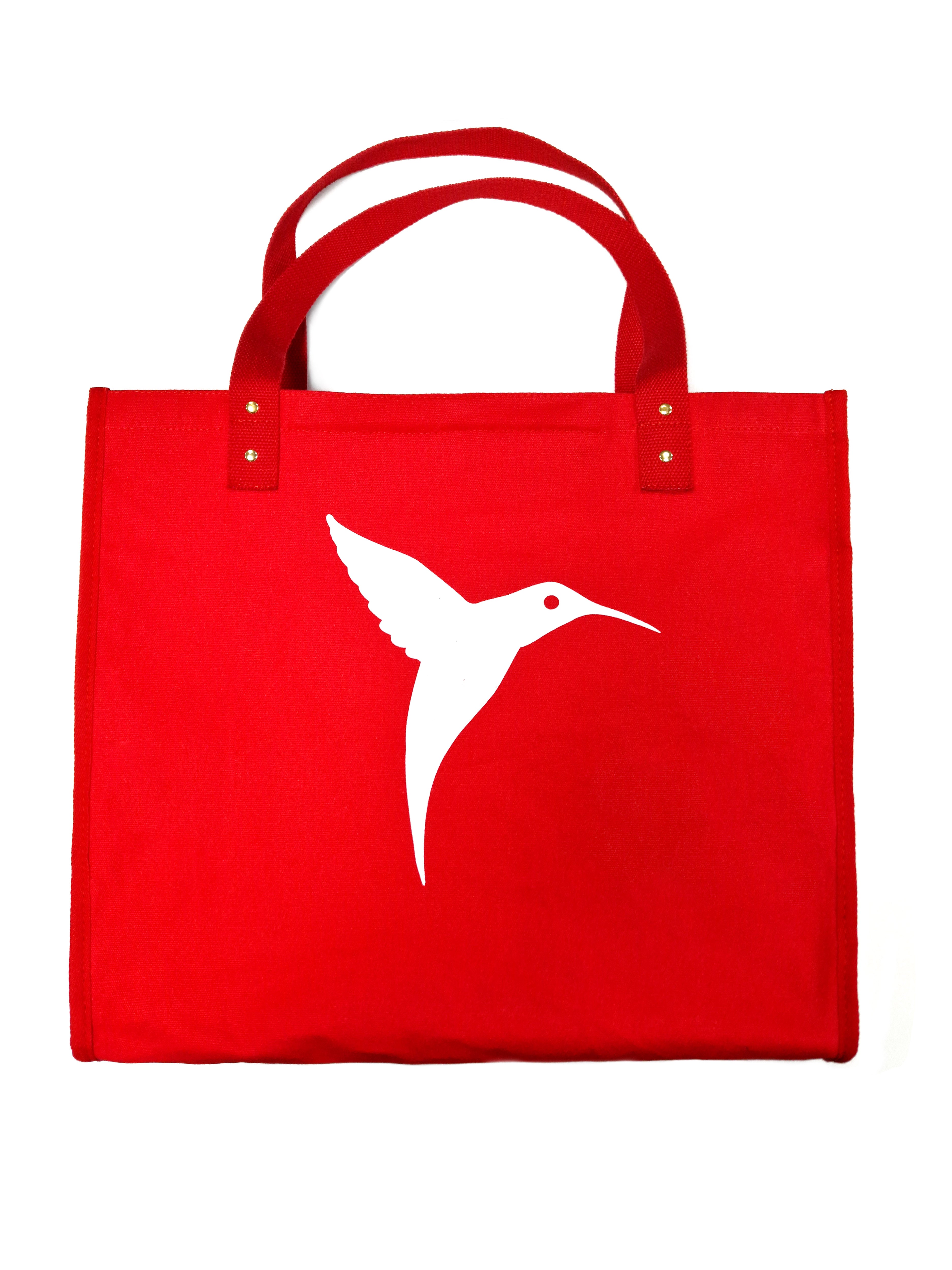 Red Ushuaïa Ibiza cotton shopping bag with large white hummingbird logo.