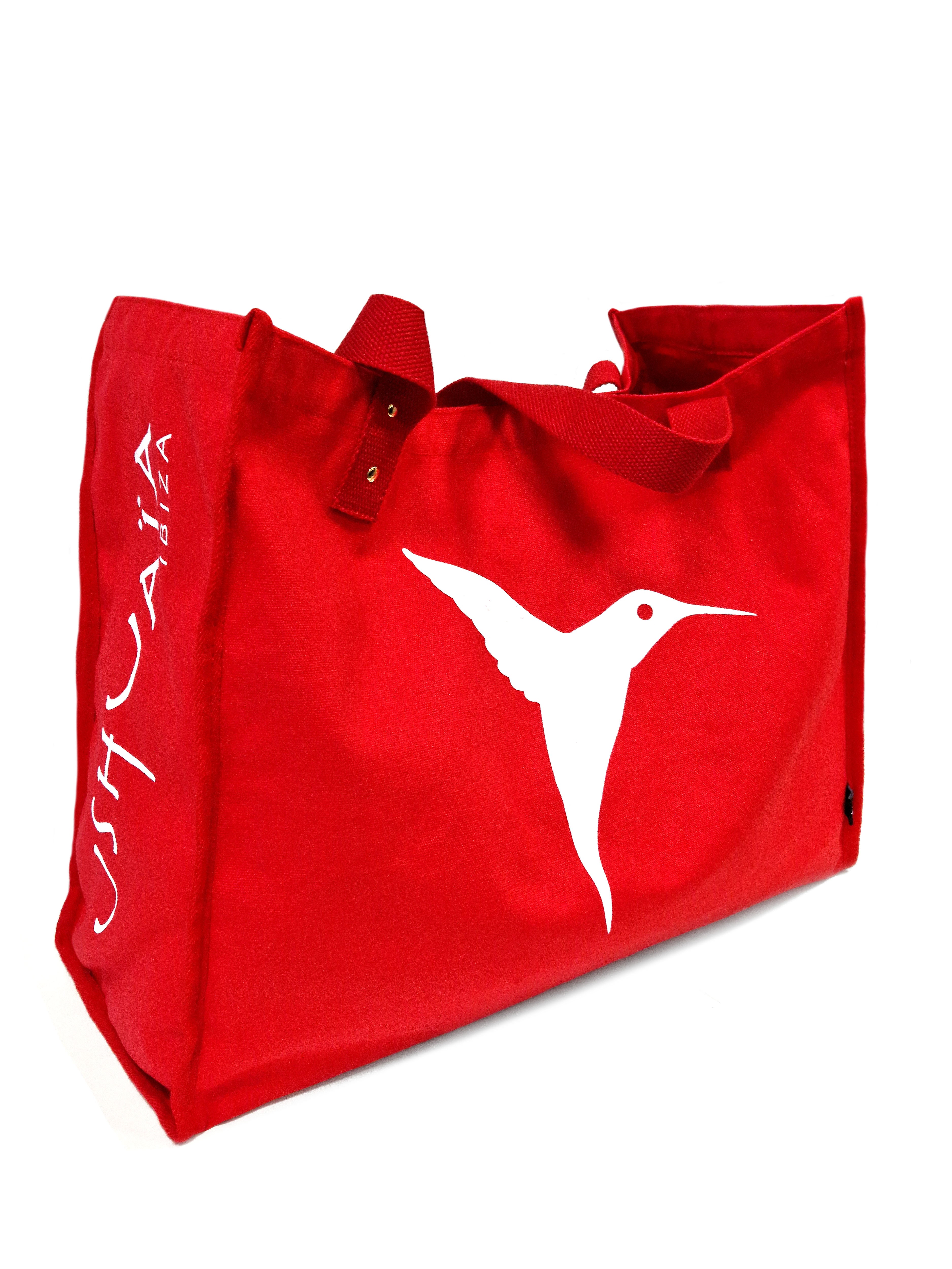 Red Ushuaïa Ibiza cotton shopping bag with large white hummingbird logo.