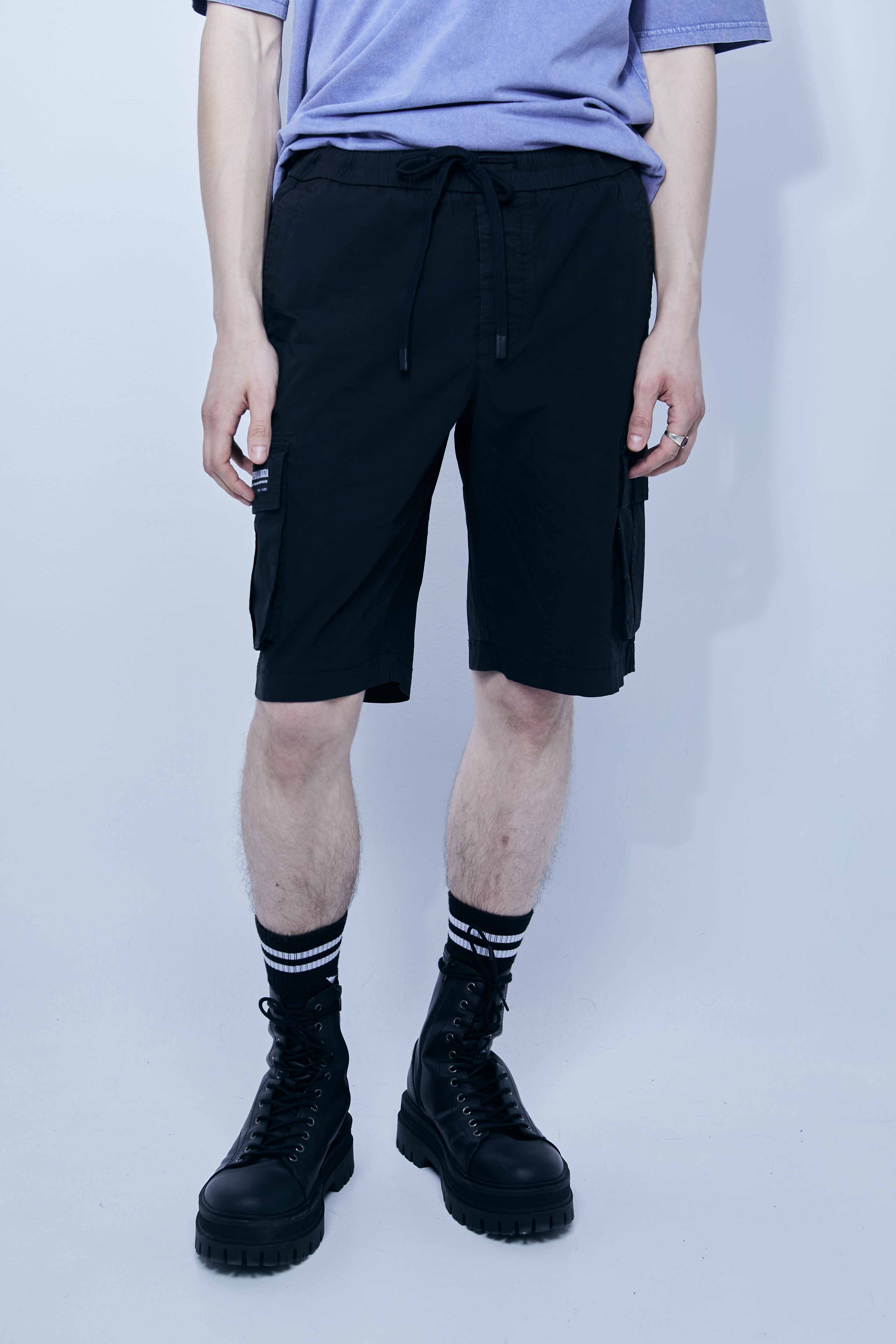 Cargo shorts made of a washed cotton blend with a fade out effect. Adjustable waistband with drawstring. Side and front cargo pockets. Rubberized patch detail on back patch pocket. Front zipper closure