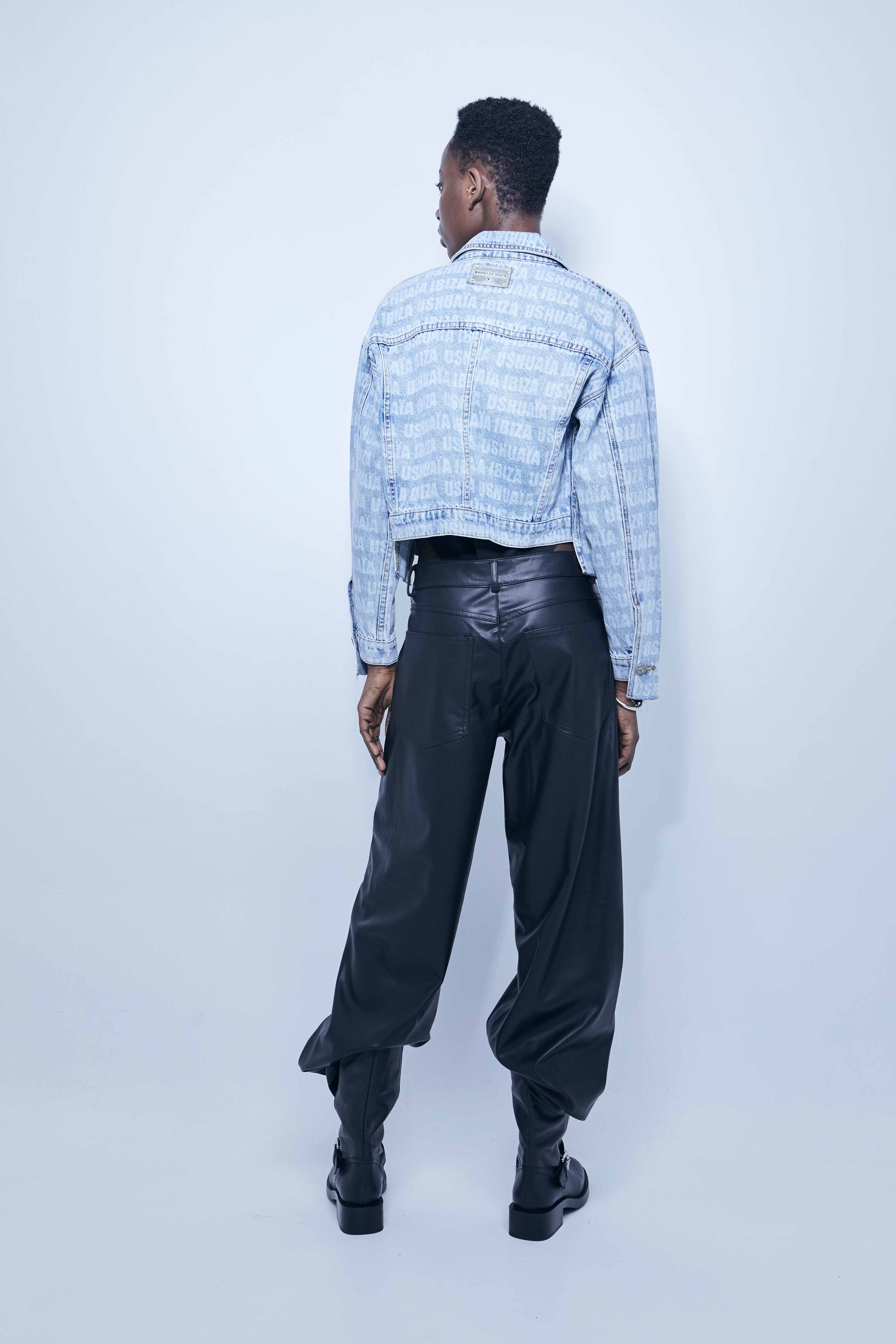 Jacket with lapel collar and long sleeves. Front pockets. Uneven hem with frayed ends. Laser print detail. Front closure with metal buttons.