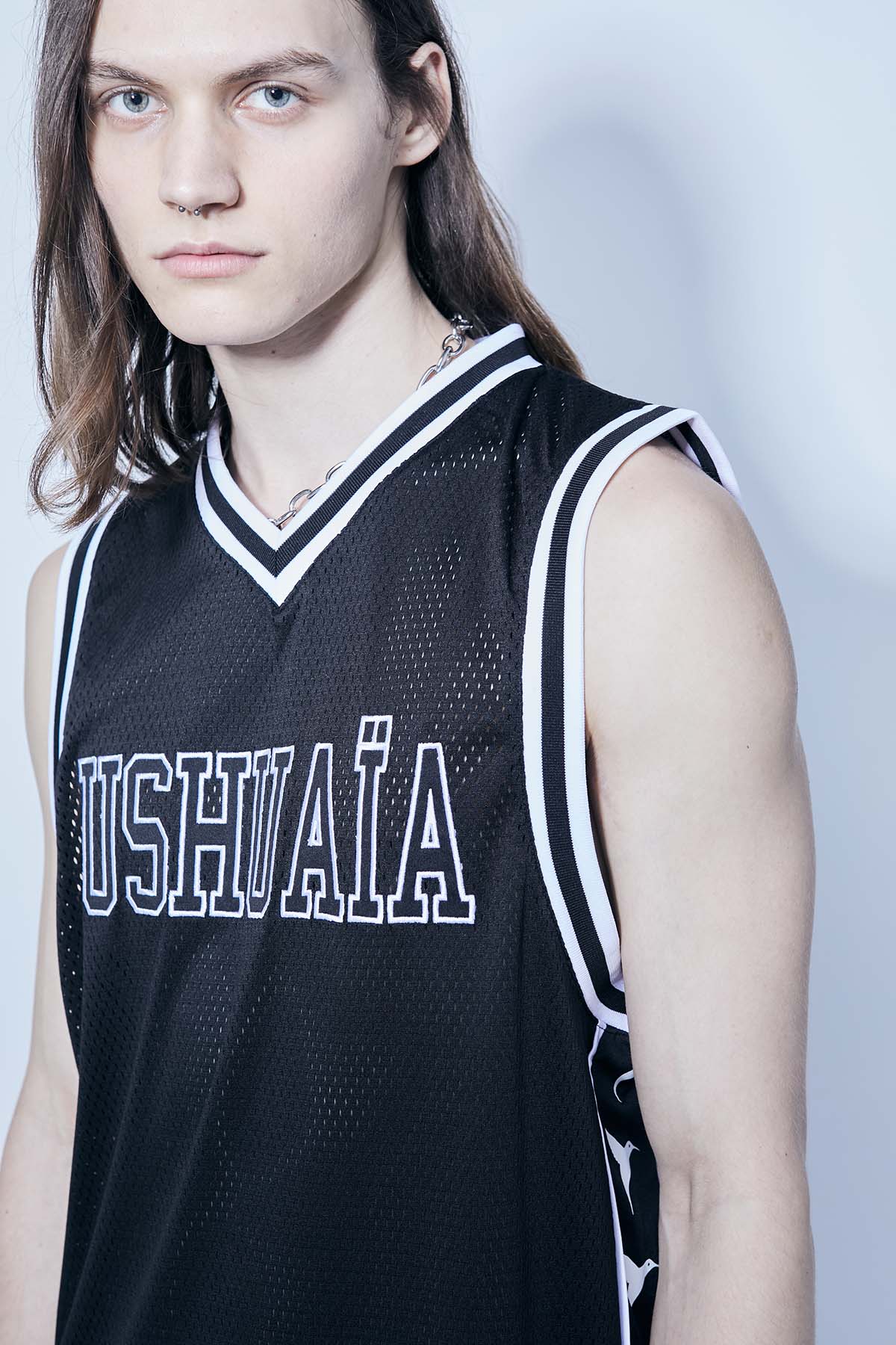 Basketball t-shirt made of mesh fabric, light and breathable. V-neck and armhole sleeves. Contrasting combined print detail on the front and back.