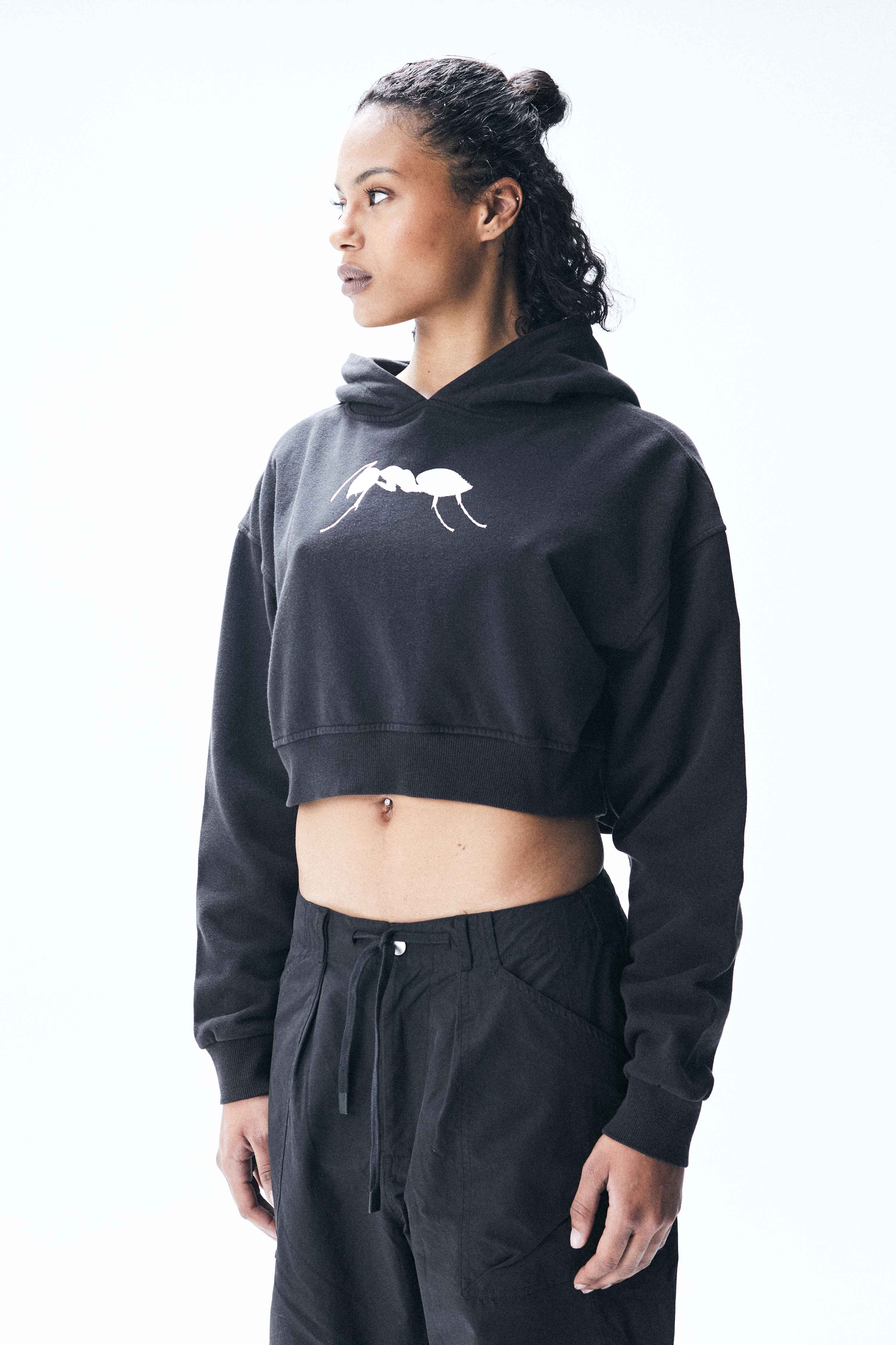 Cropped hoodie with long sleeves and faded wash effect. Front graphic print with contrasting details.