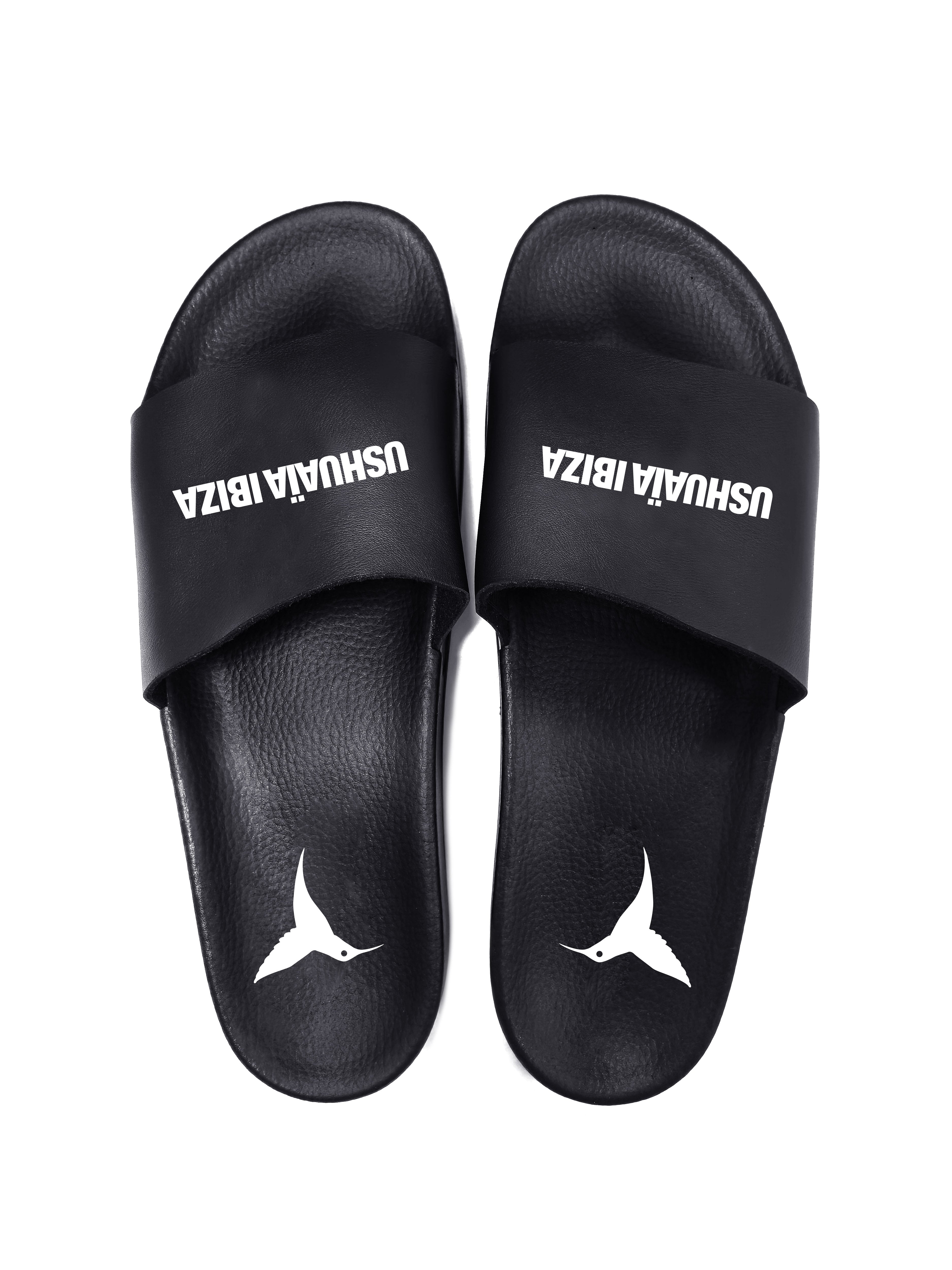 Black flip flops with white logo.Polyurethane sole with cotton and polyester lining.Screen printing and engraving in high frecuency.