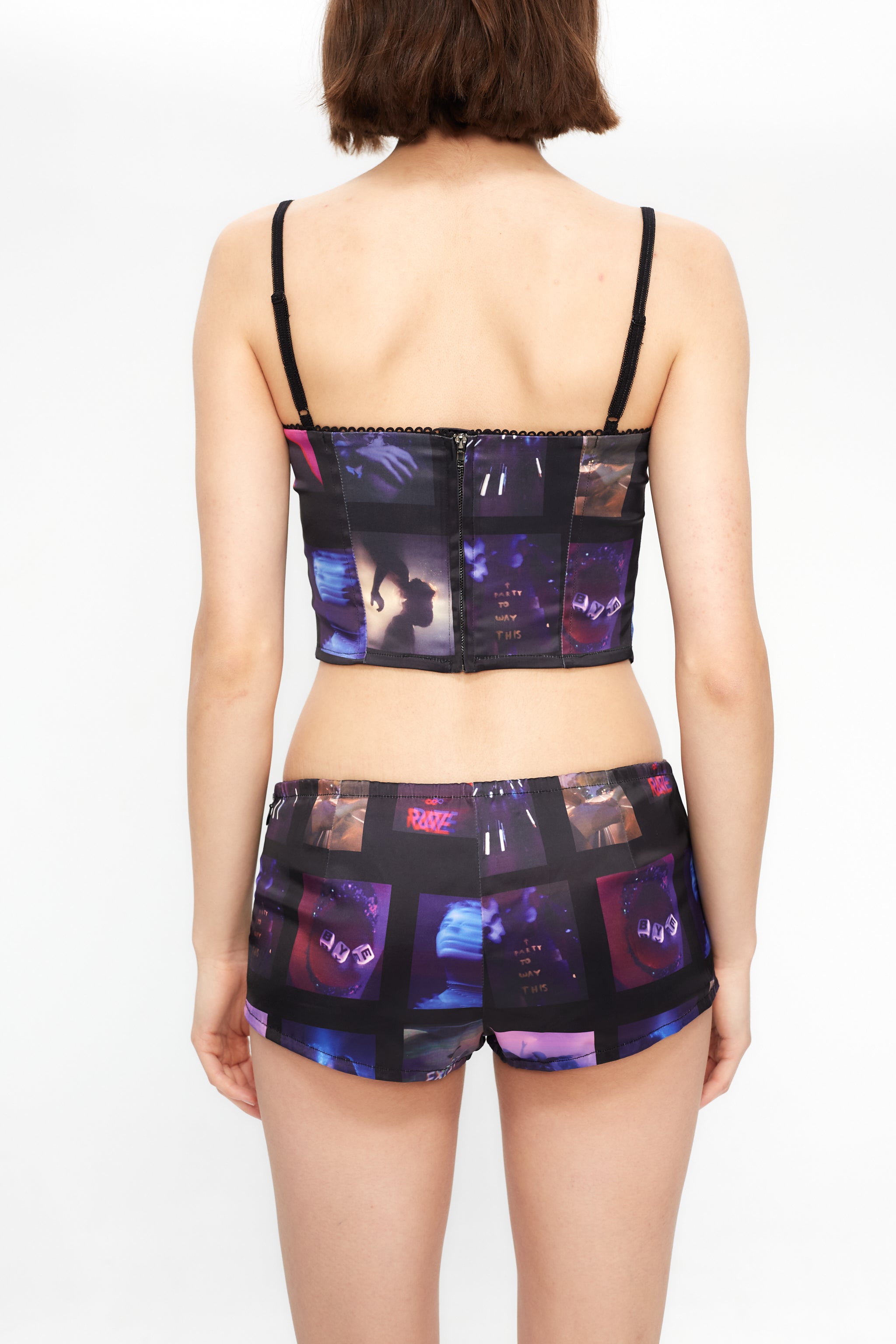 Printed tank top with corset cut and adjustable straps. Central zipper detail on the back.