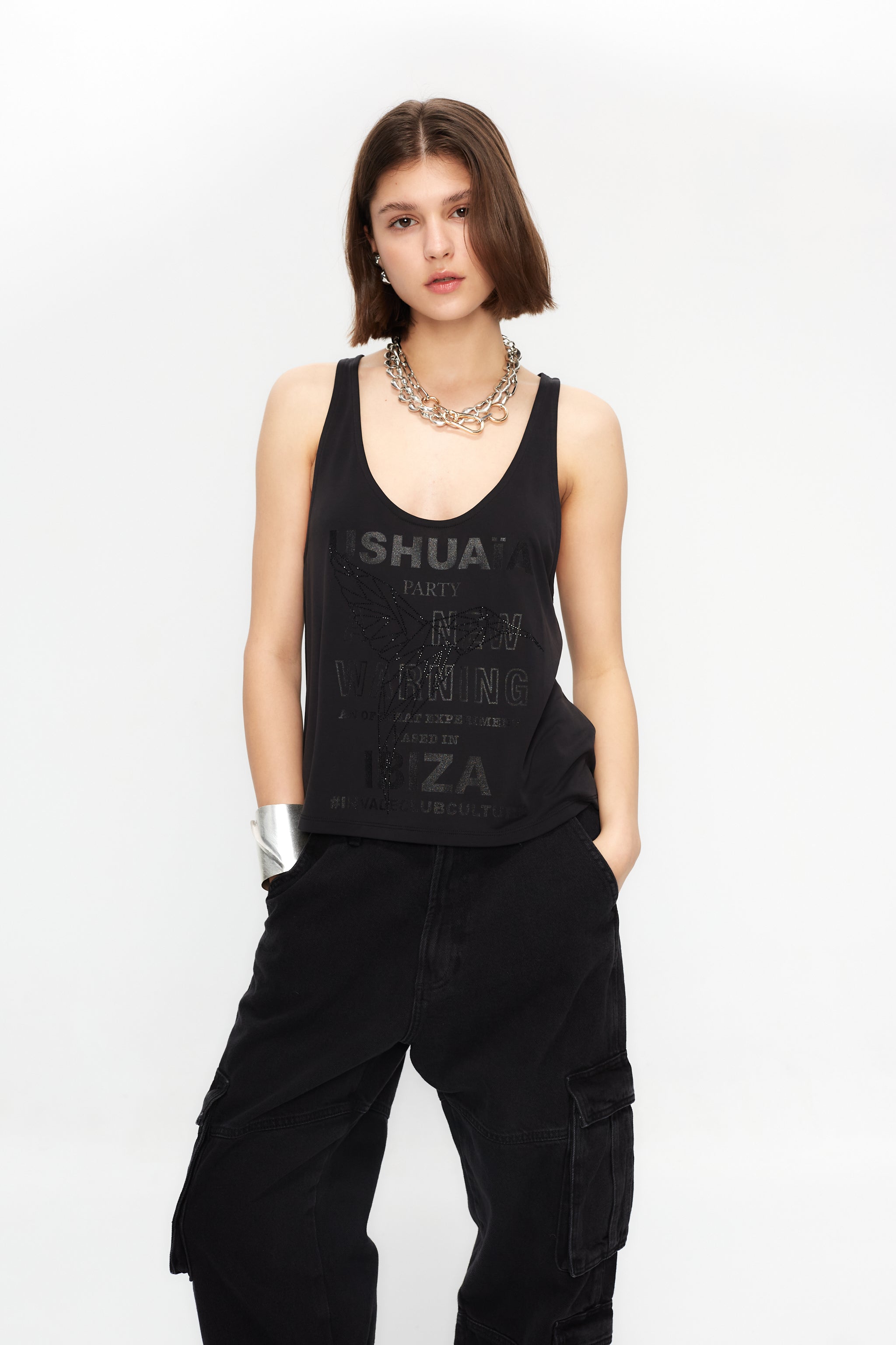 Black loose-fit tank with glitter effect & rhinestone details. Perfect for bold Ibiza looks. Shop your statement vibe now!