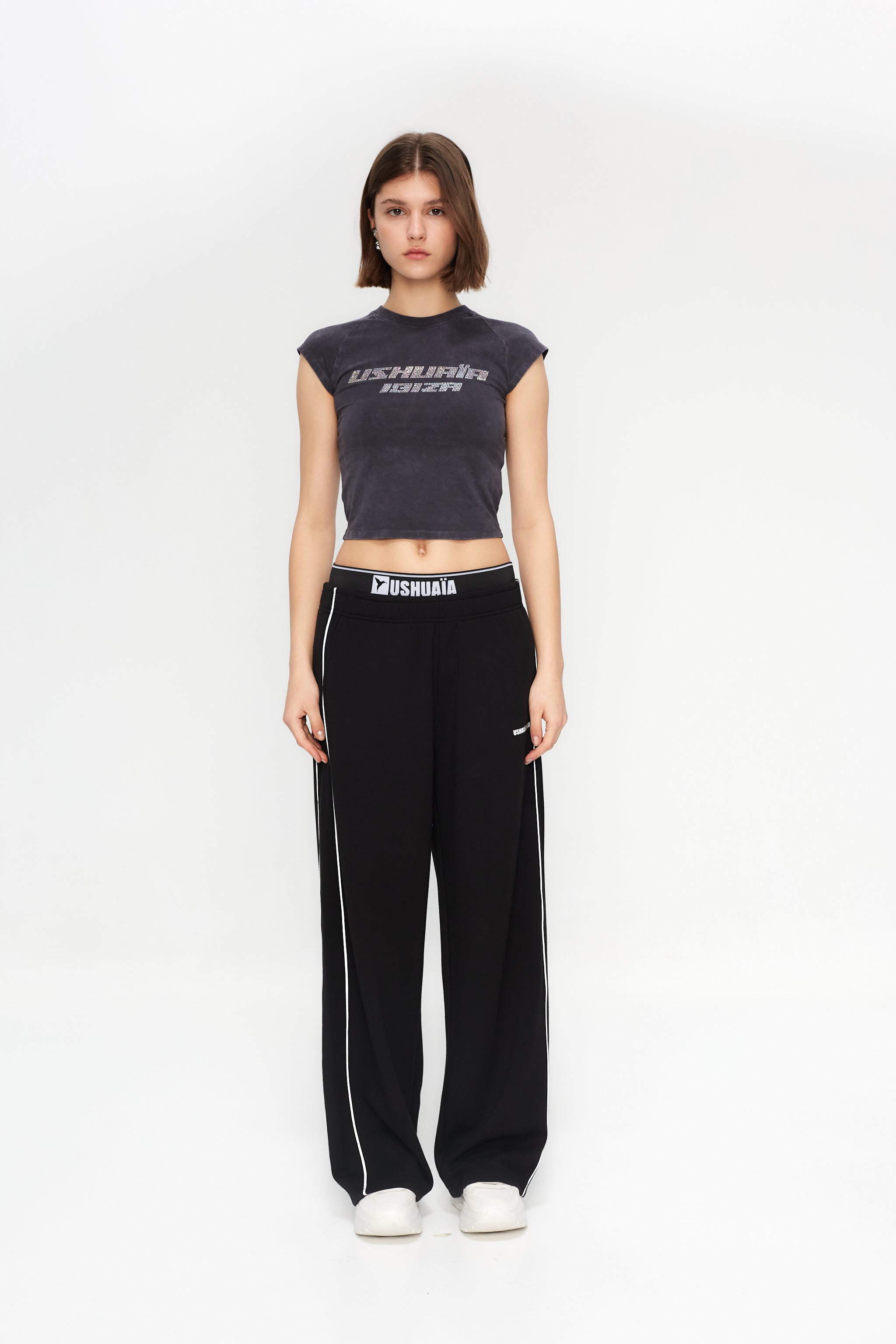 Wide-leg trousers with elastic waistband. Features side print detail and reflective piping.