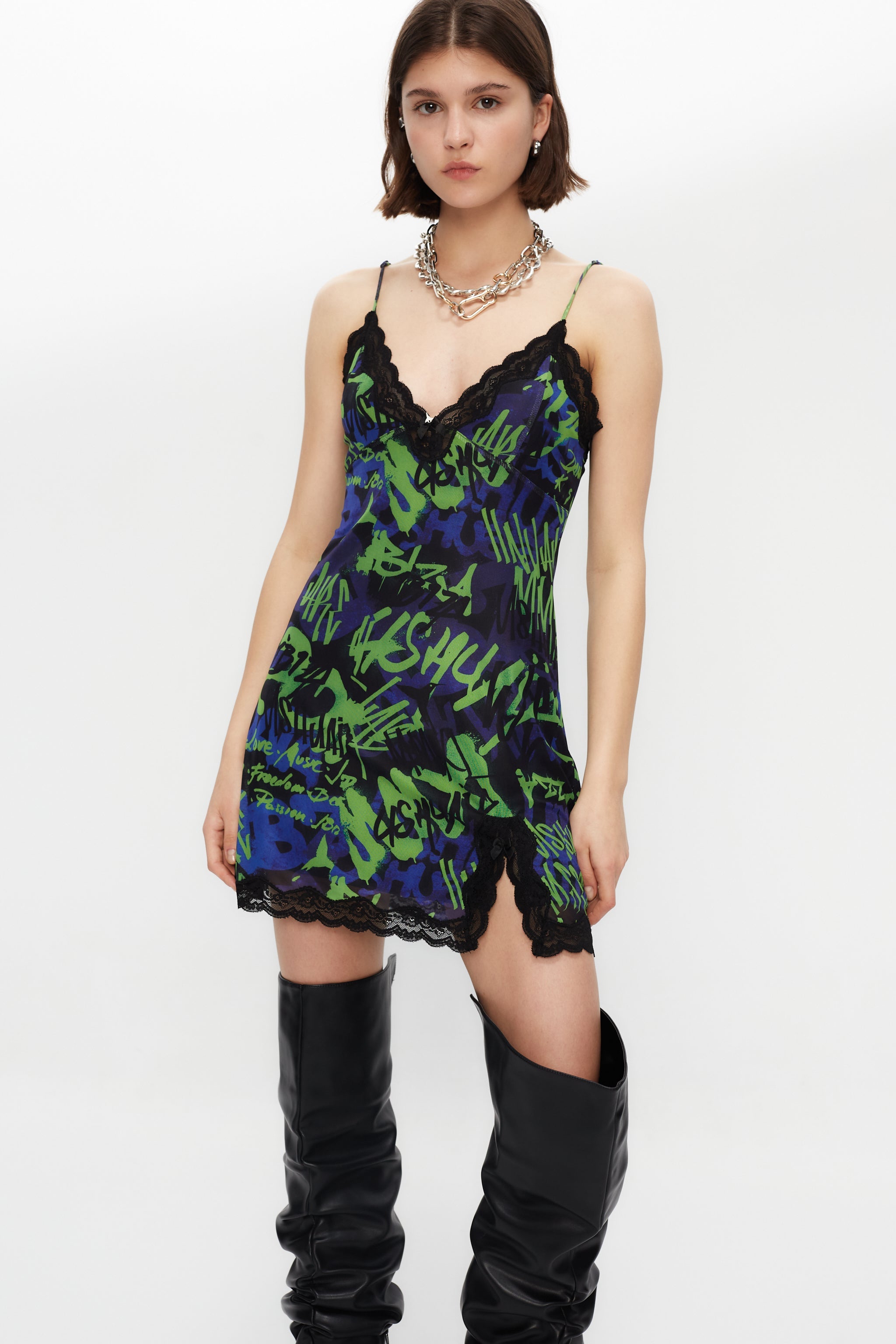 Elastic printed lingerie dress with lining. Adjustable straps. Lace and bow detail with metallic ornament on neckline and hem opening.