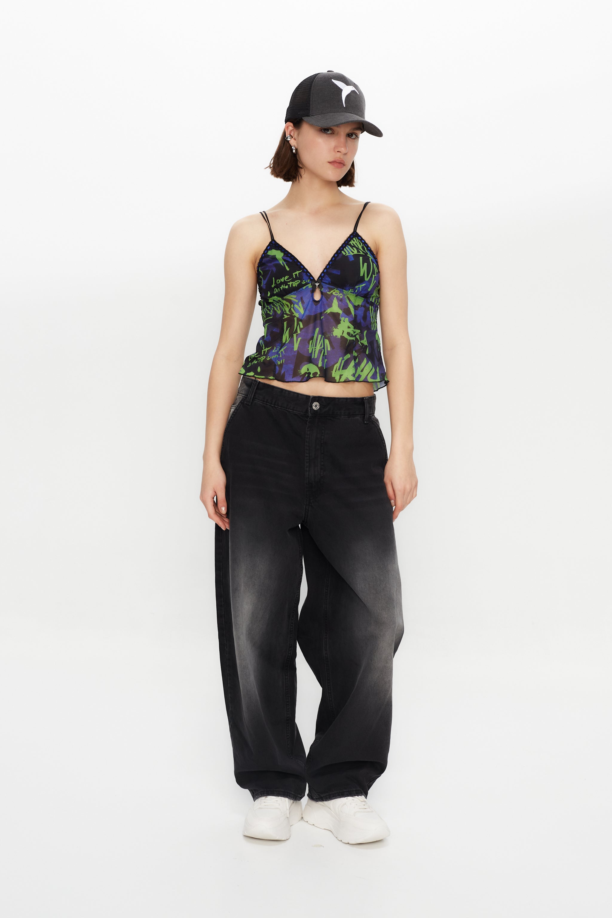 Printed lingerie tank top with adjustable straps. Bow detail with metallic ornament.