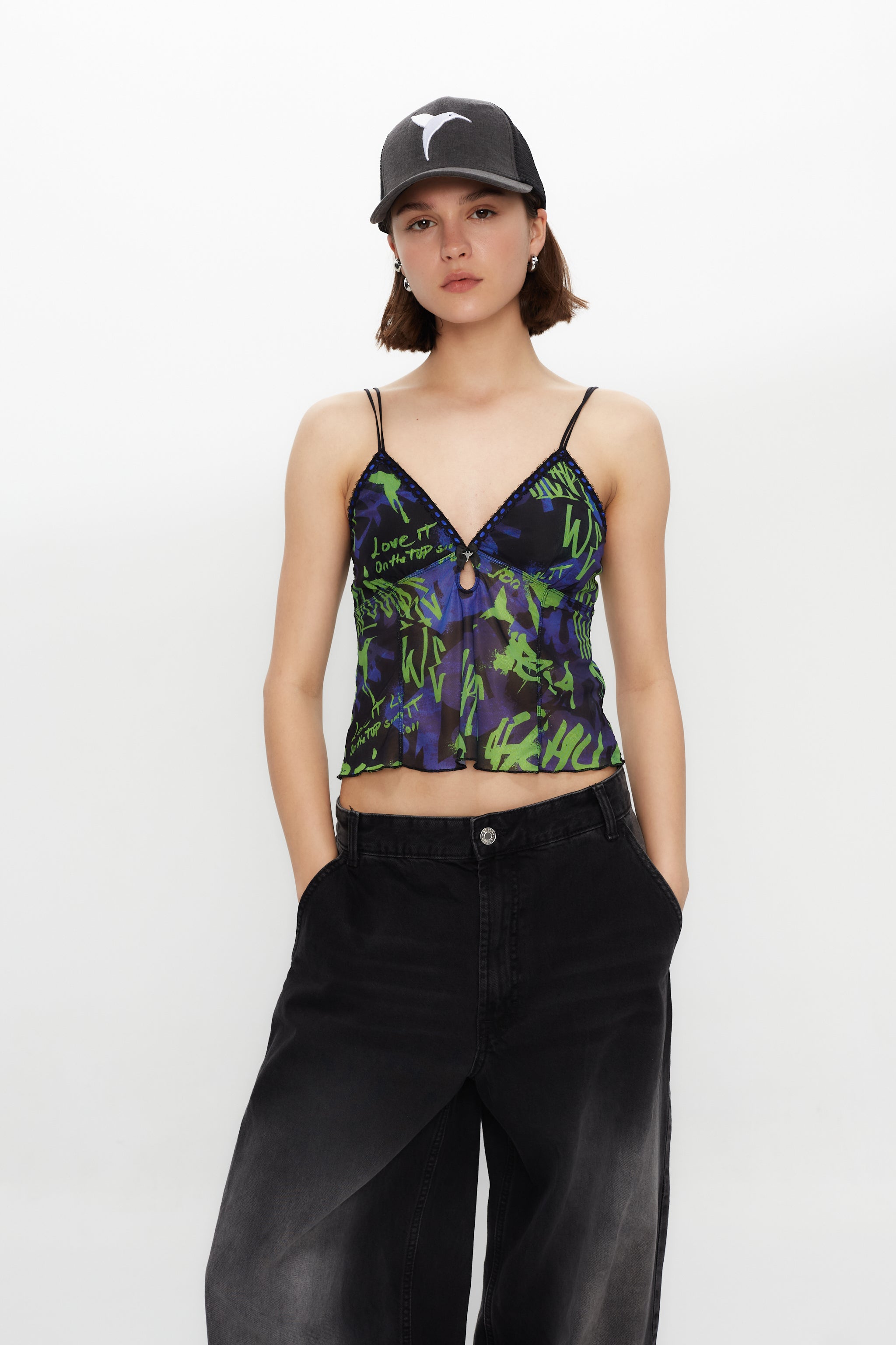 Printed lingerie tank top with adjustable straps. Bow detail with metallic ornament.