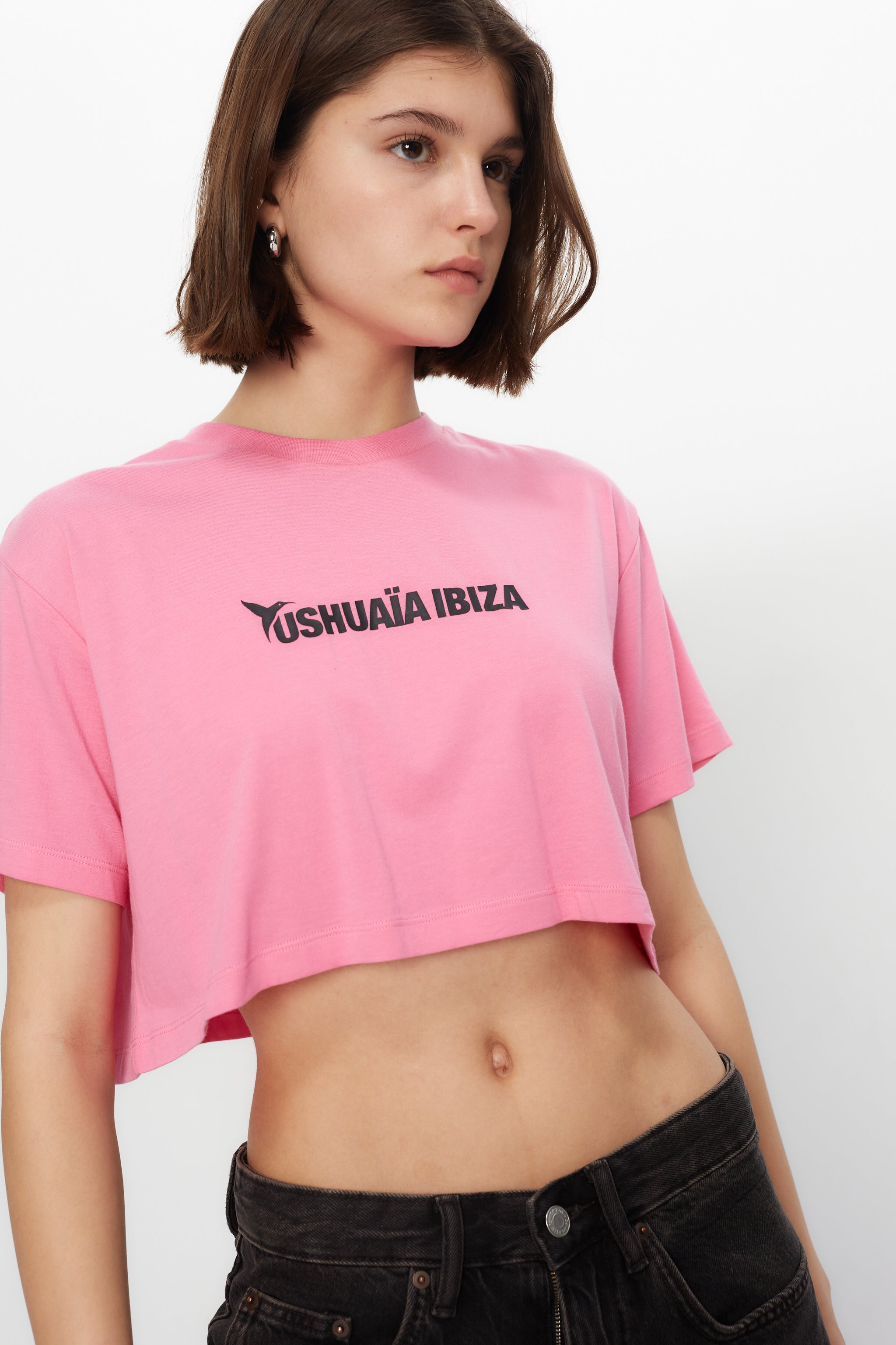 Pink cropped T-shirt with bold Ibiza print & contrast details. Perfect for summer streetwear looks. Shop the vibe now!