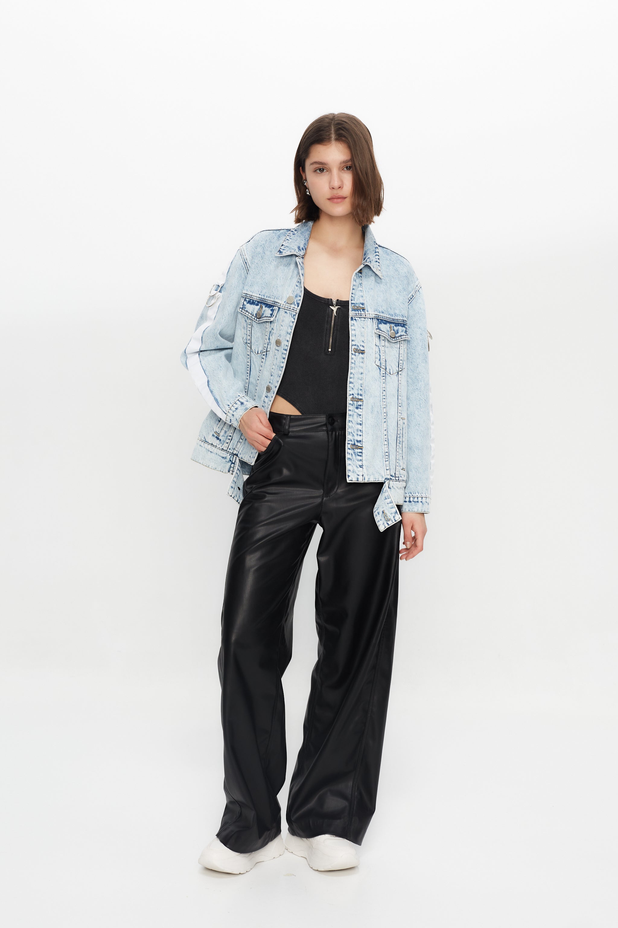 Denim jacket with a back panel featuring an appliqué with applied text and embroidery. Side sleeve panel embroidered with silver eyelet finish.