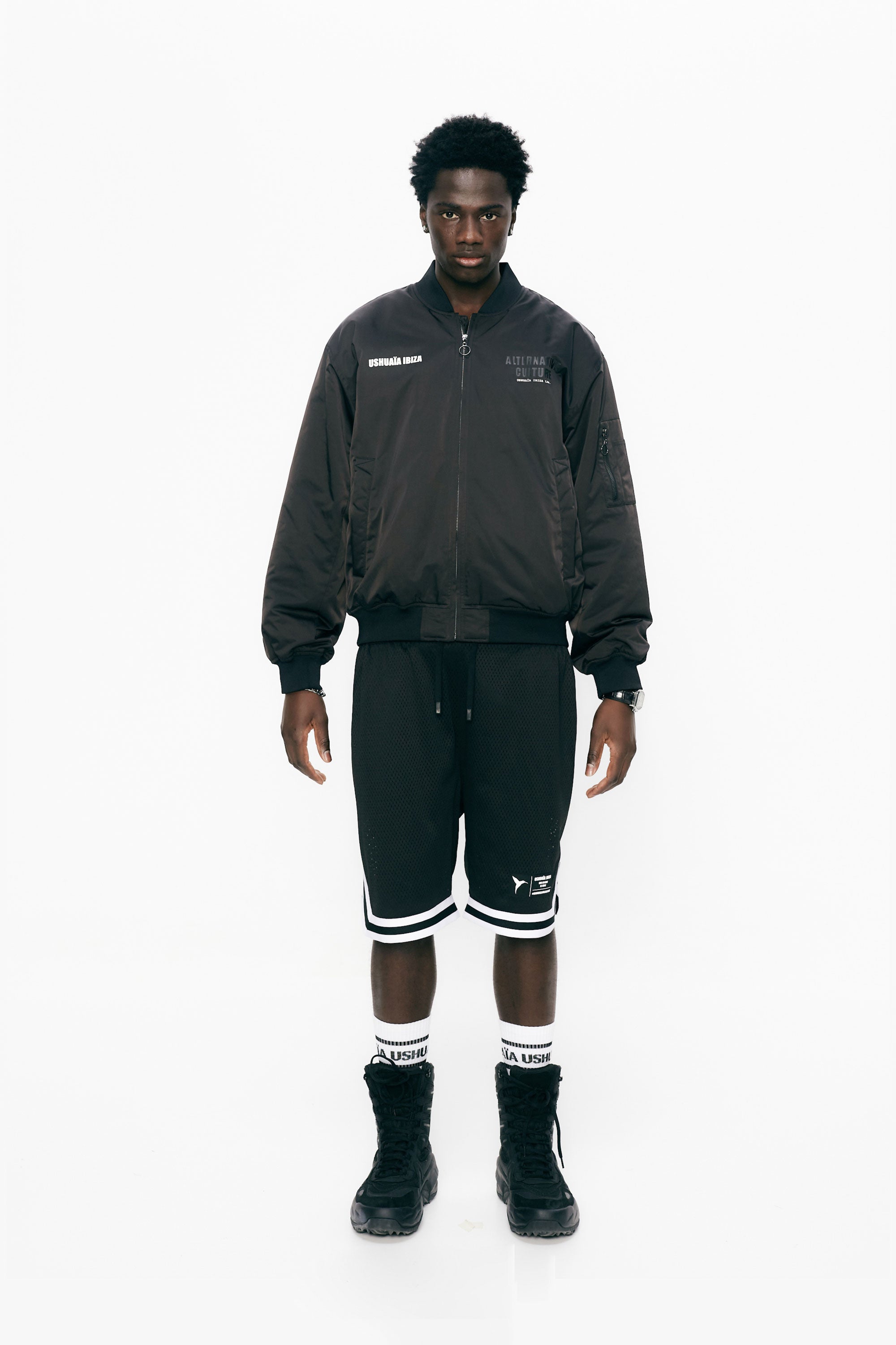 Satin bomber jacket with elastic collar and long sleeves. Rubber print detail on the front and fabric and embroidery application on the back. Front welt pockets. Sleeve pocket with custom puller. Front closure with two-way zipper. Ribbed finishes.