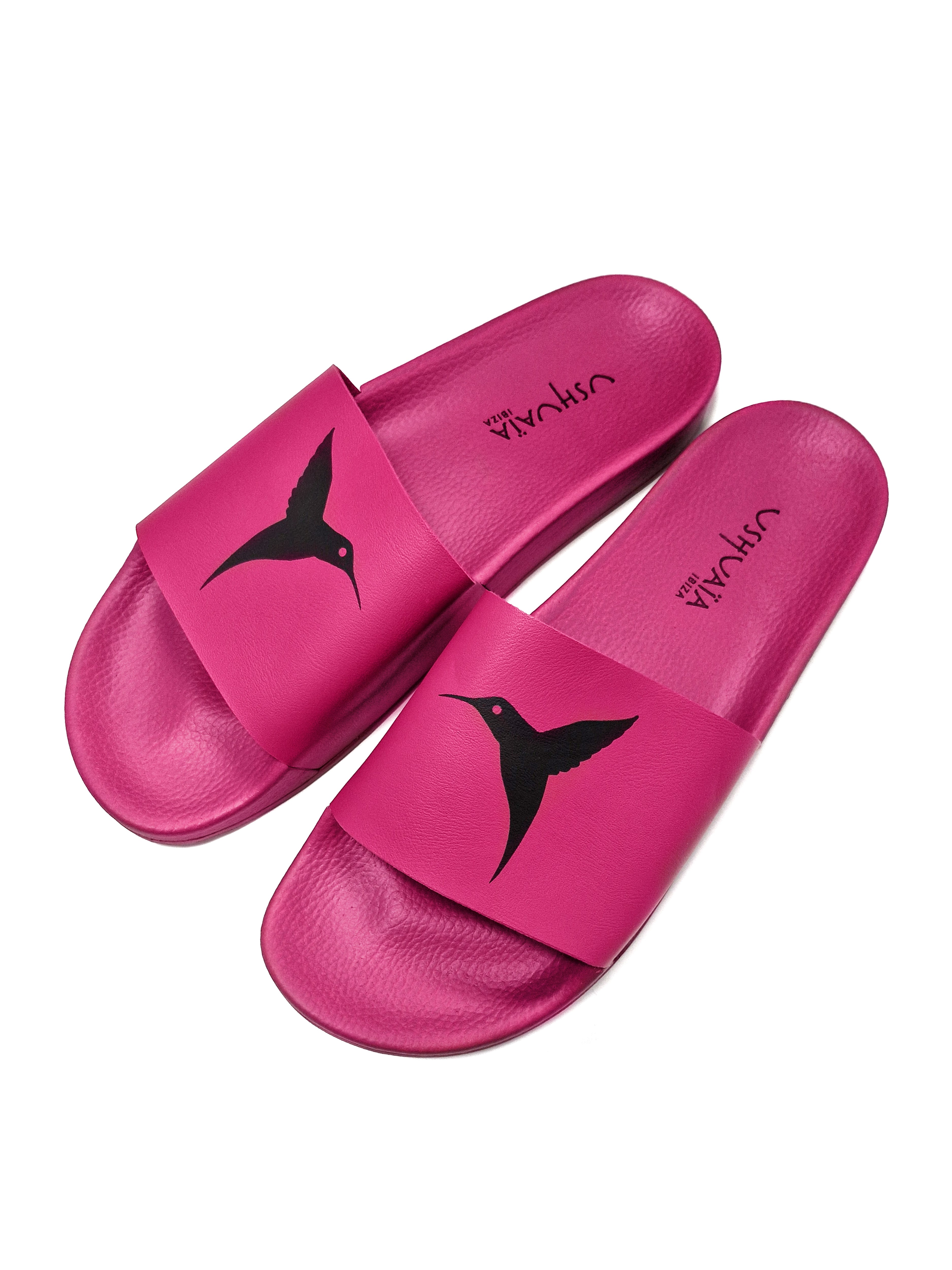 Pink flip-flops with black logo