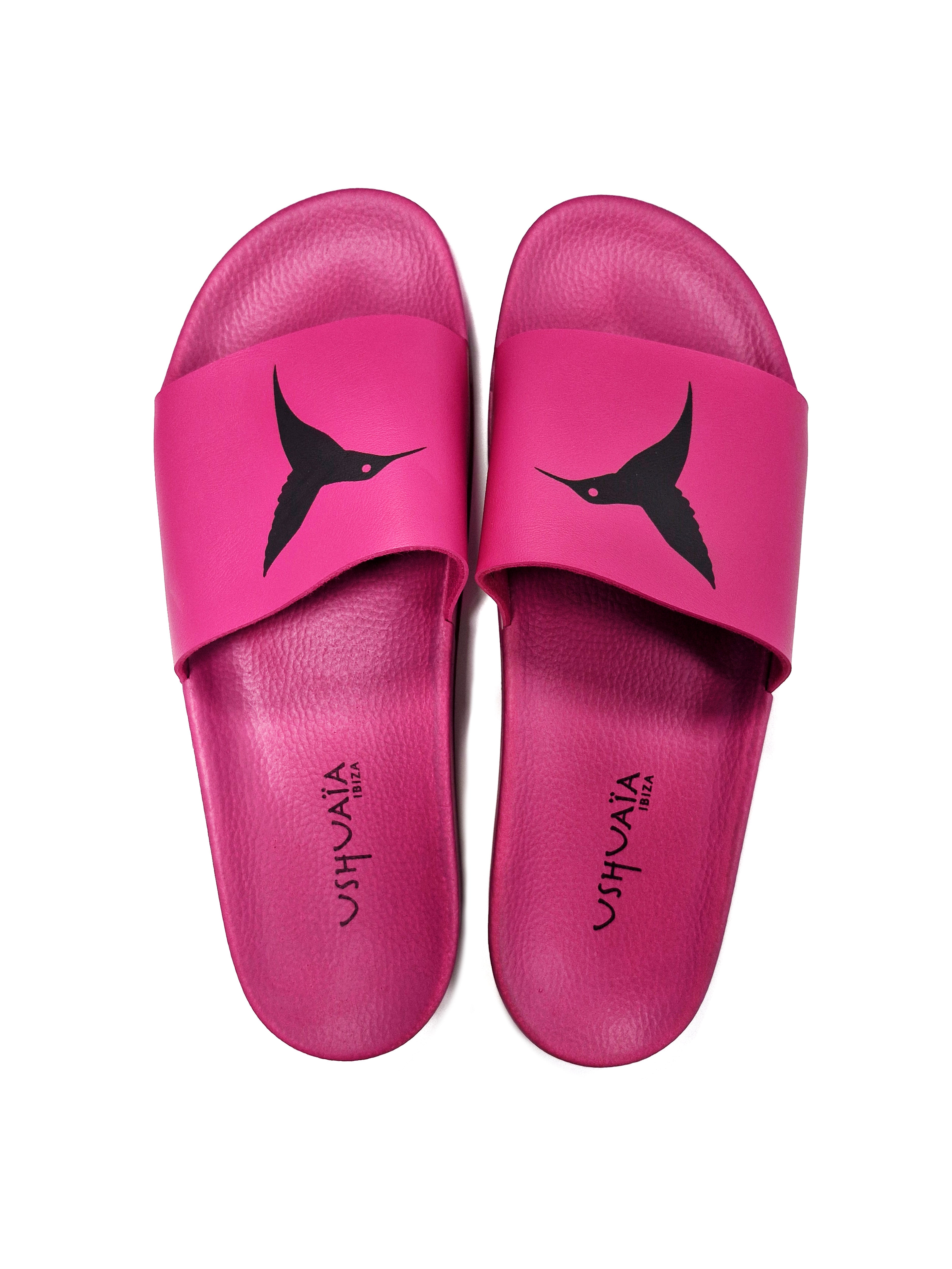Pink flip-flops with black logo