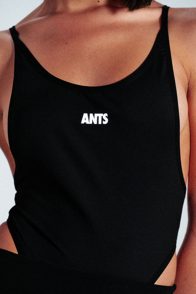 Stretch strap bodysuit made from technical fabric: 75% nylon and 25% elastane. Slim fit design with ANTS logo on the front