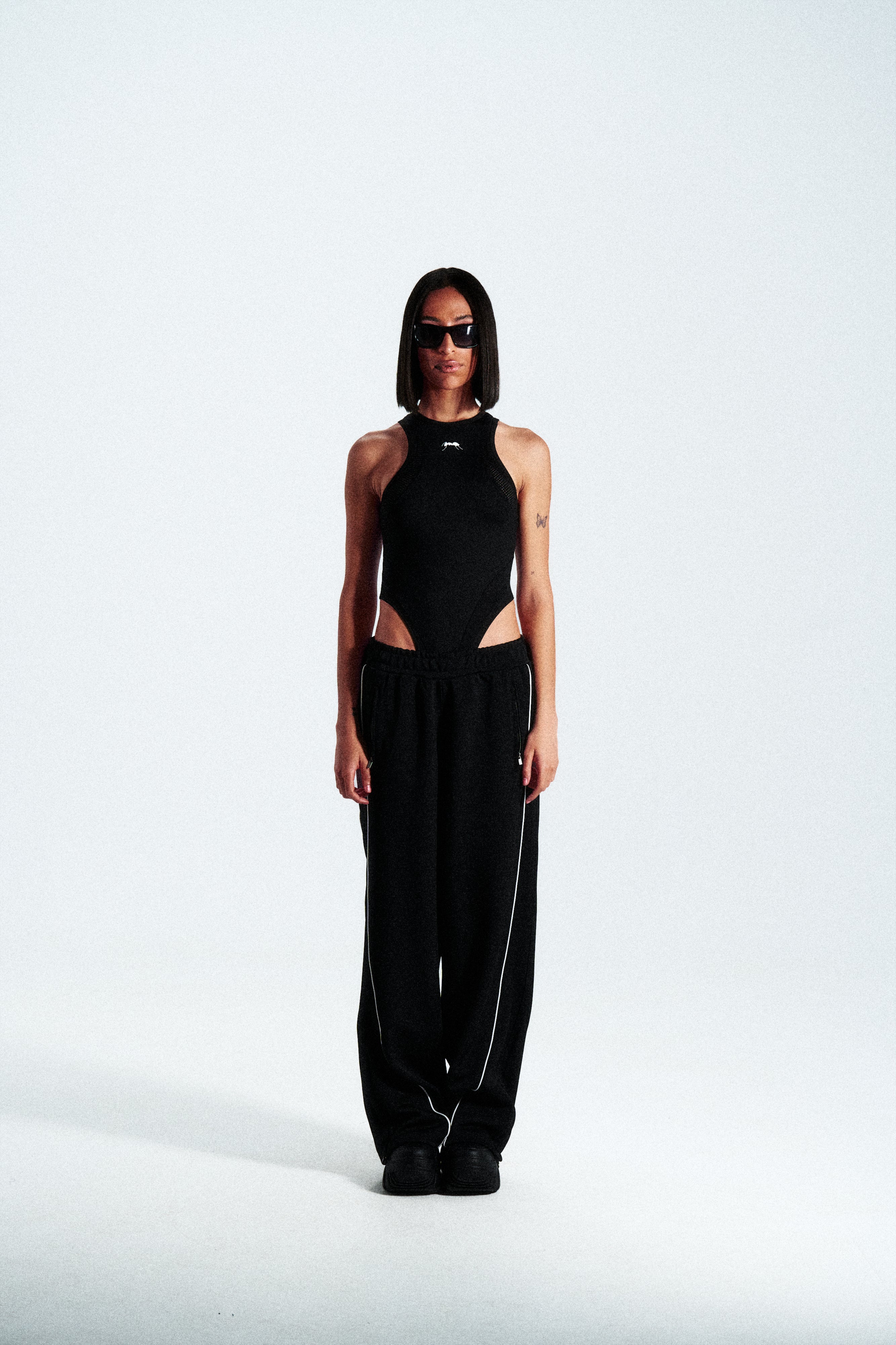Sleeveless shaping bodysuit made from stretch technical fabric. Available in black. Worldwide shipping.