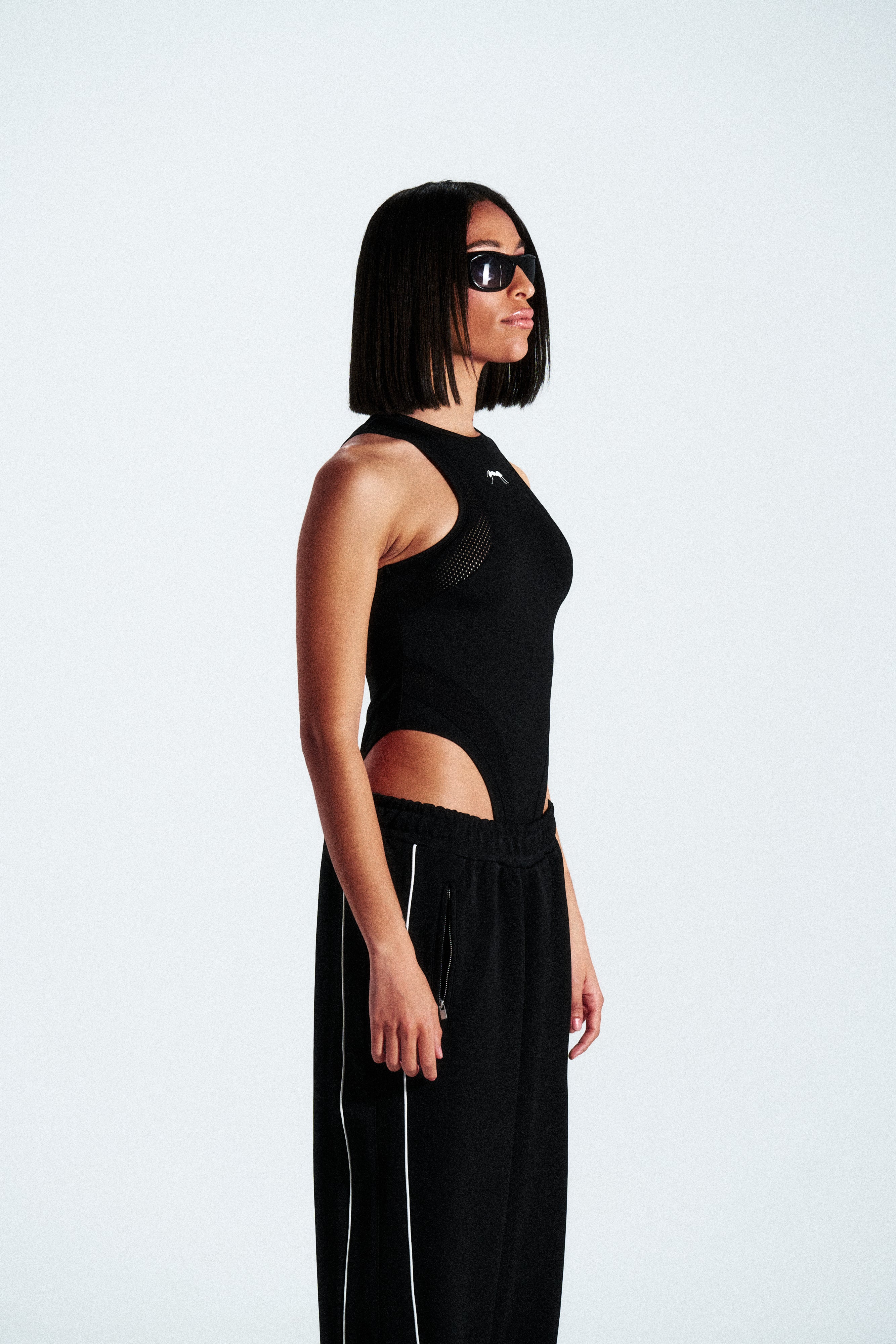 Sleeveless shaping bodysuit made from stretch technical fabric. Available in black. Worldwide shipping.