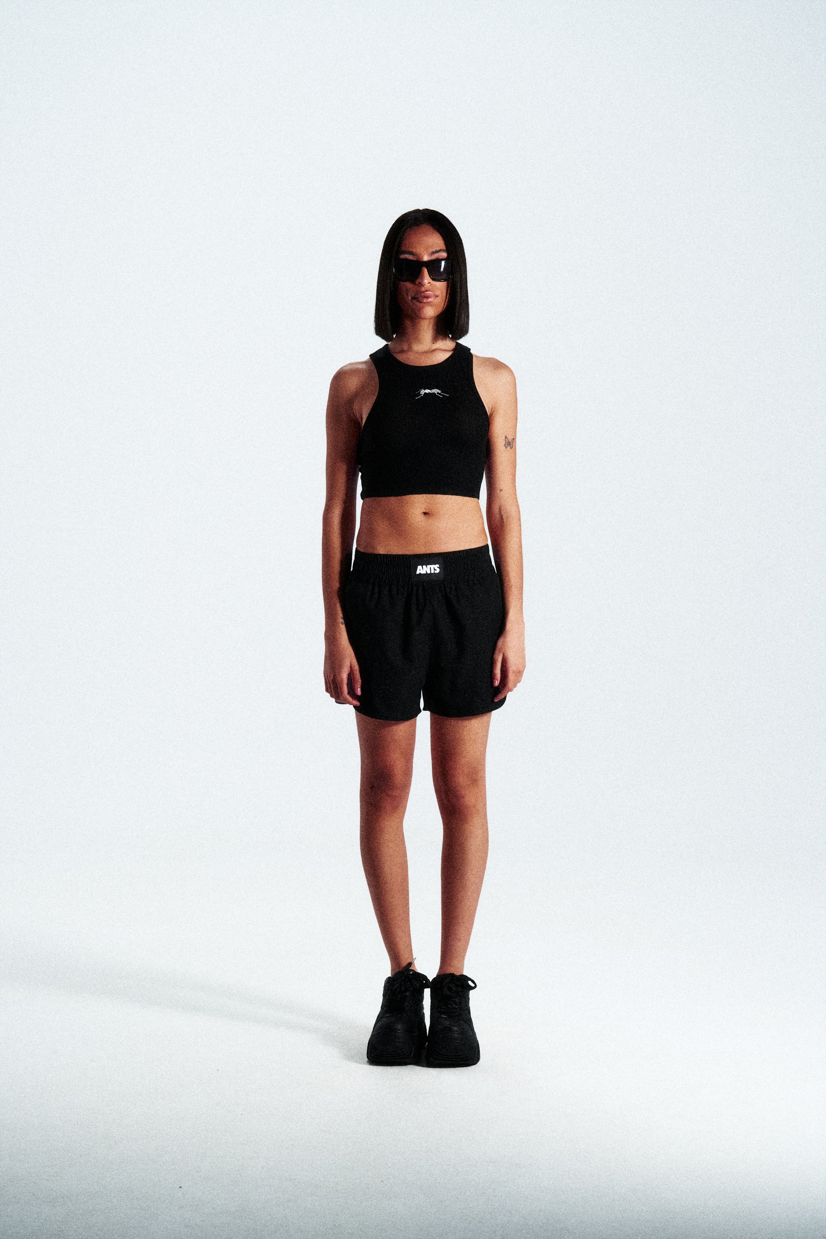High-waisted ANTS performance shorts with elastic waistband and bold hem logo. Premium stretch fabric.
