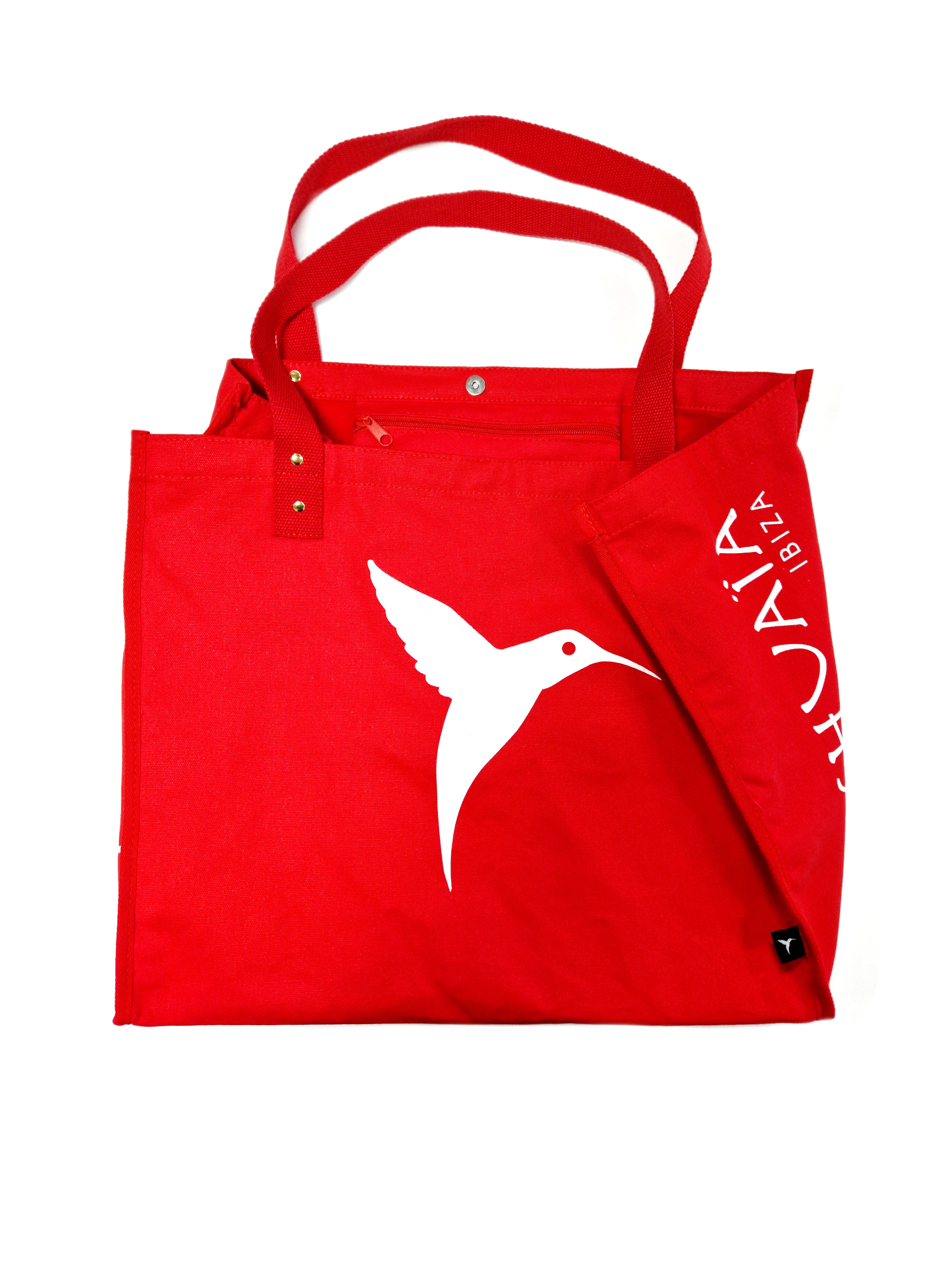 Red Ushuaïa Ibiza cotton shopping bag with large white hummingbird logo.