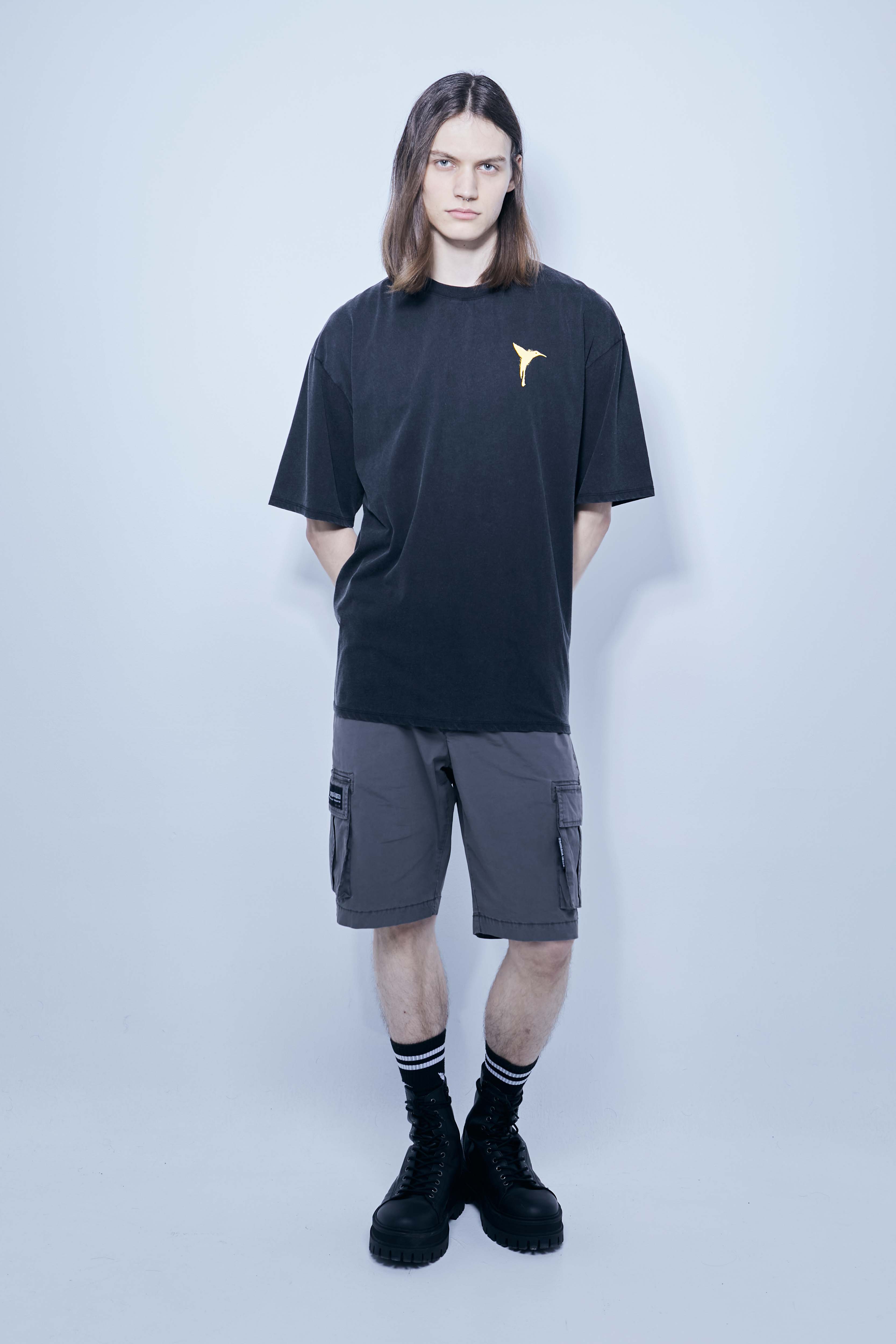 Cargo shorts made of a washed cotton blend with a fade out effect. Adjustable waistband with drawstring. Side and front cargo pockets. Rubberized patch detail on back patch pocket. Front zipper closure