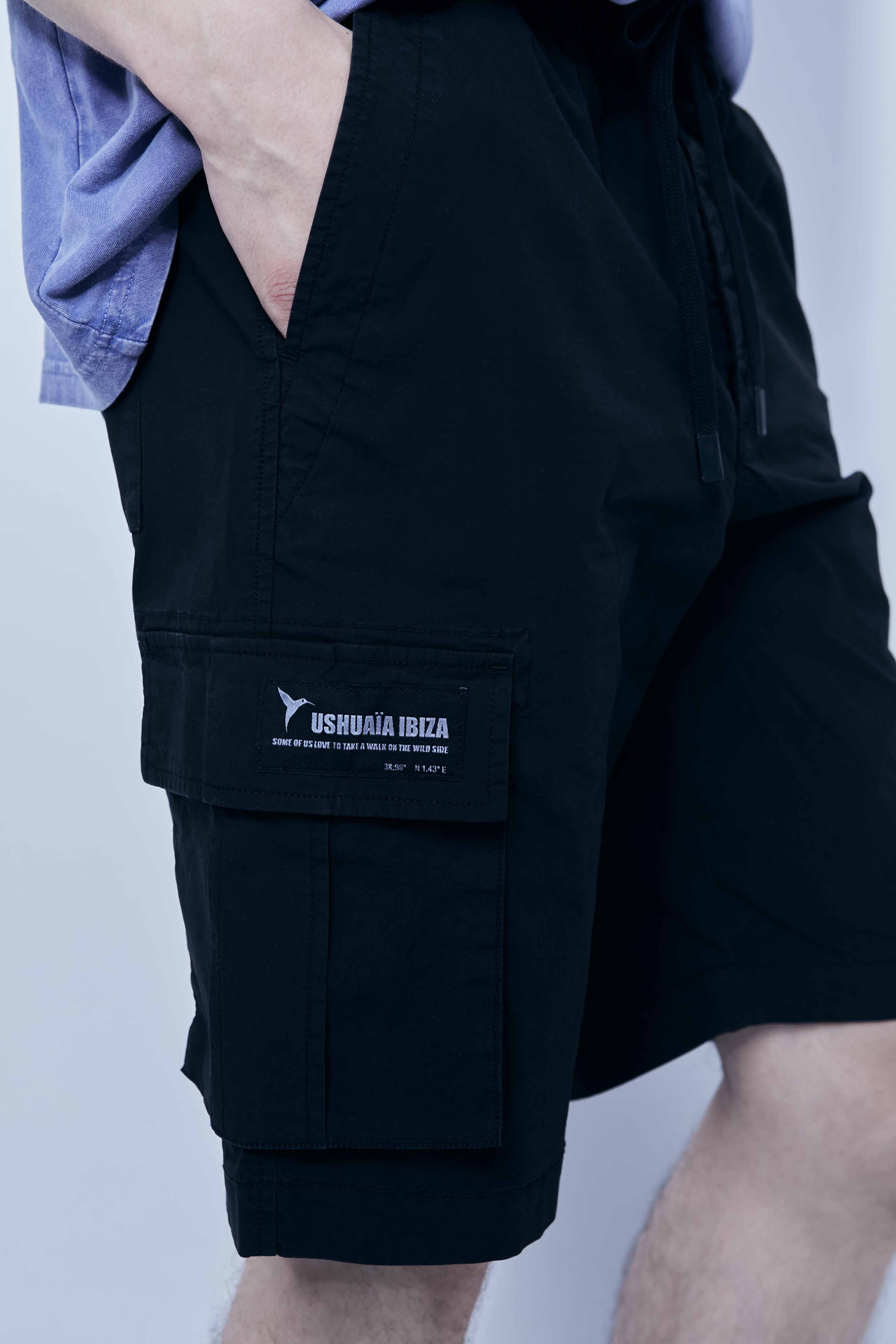  Cargo shorts made of a washed cotton blend with a fade out effect. Adjustable waistband with drawstring. Side and front cargo pockets. Rubberized patch detail on back patch pocket. Front zipper closure