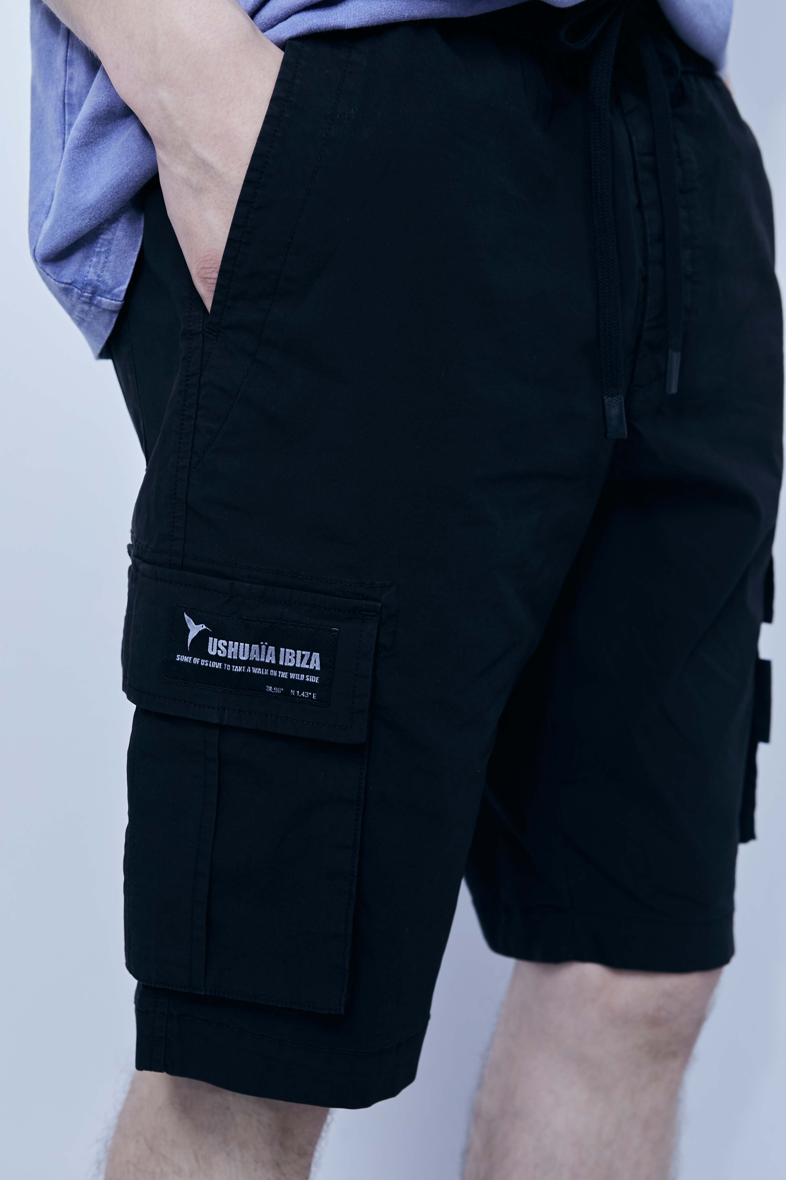 Cargo shorts made of a washed cotton blend with a fade out effect. Adjustable waistband with drawstring. Side and front cargo pockets. Rubberized patch detail on back patch pocket. Front zipper closure