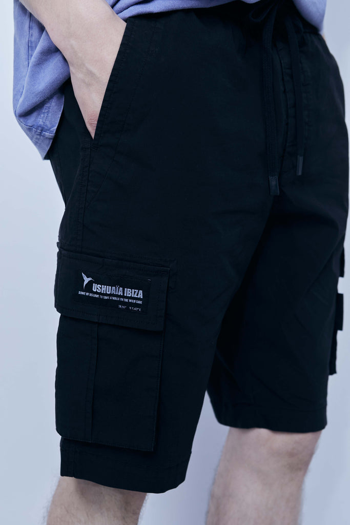 Cargo shorts made of a washed cotton blend with a fade out effect. Adjustable waistband with drawstring. Side and front cargo pockets. Rubberized patch detail on back patch pocket. Front zipper closure