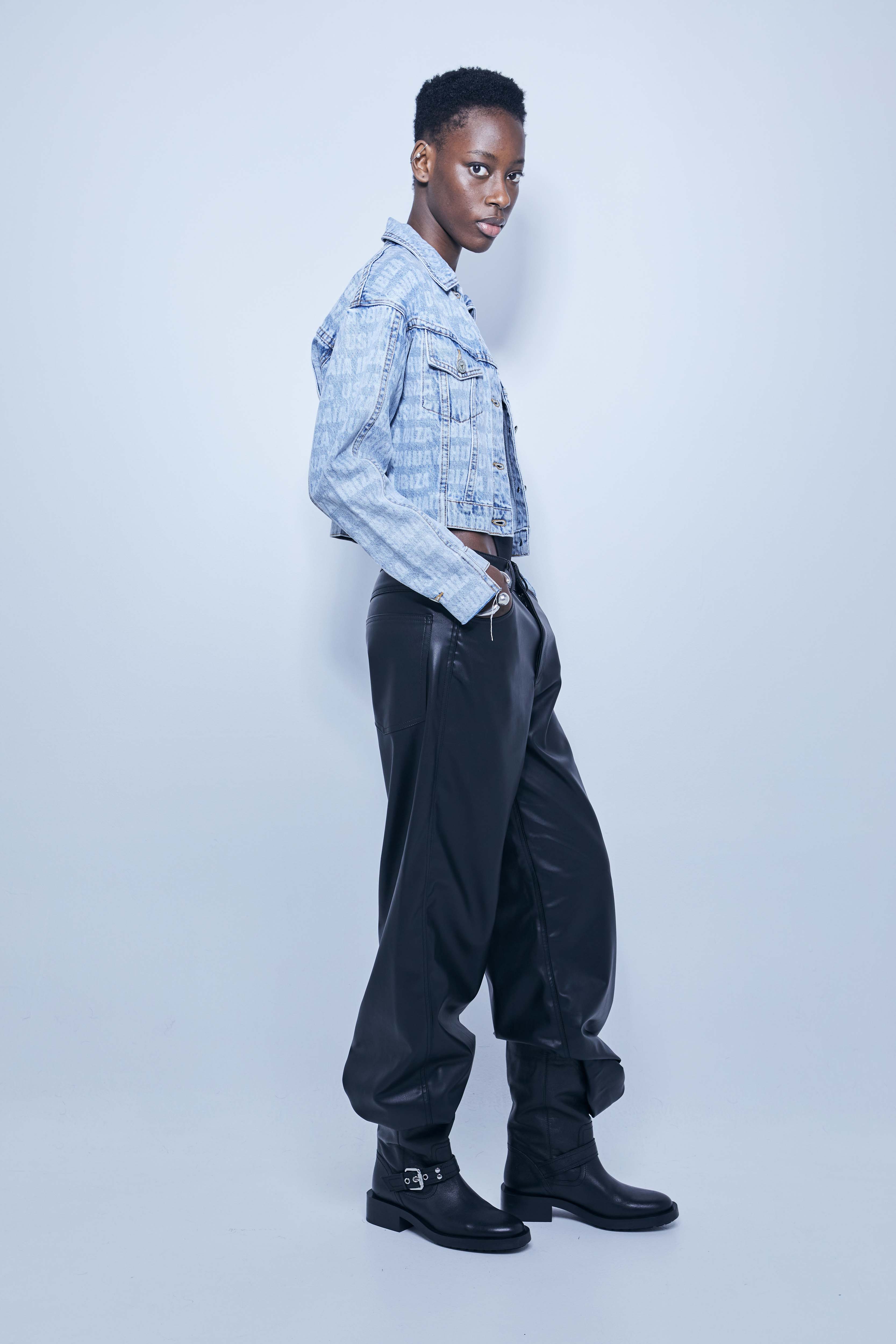 Jacket with lapel collar and long sleeves. Front pockets. Uneven hem with frayed ends. Laser print detail. Front closure with metal buttons.