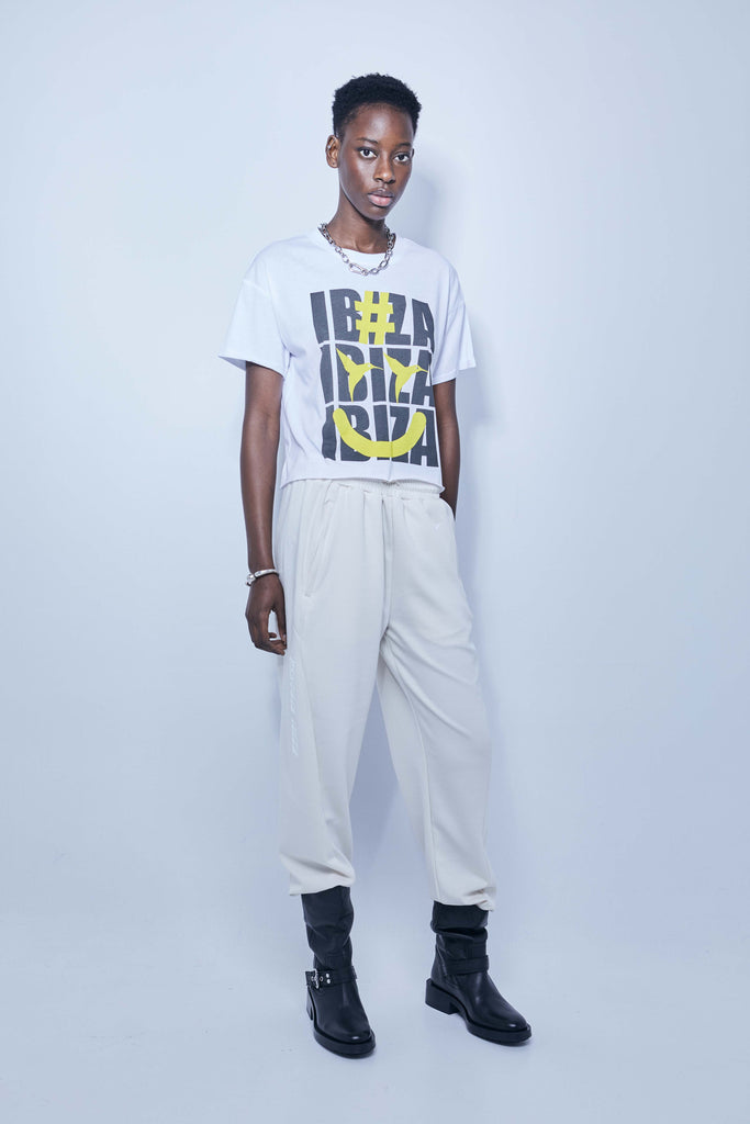 White T-shirt with oversized yellow and black Ibiza print – Ushuaïa summer streetwear essential.