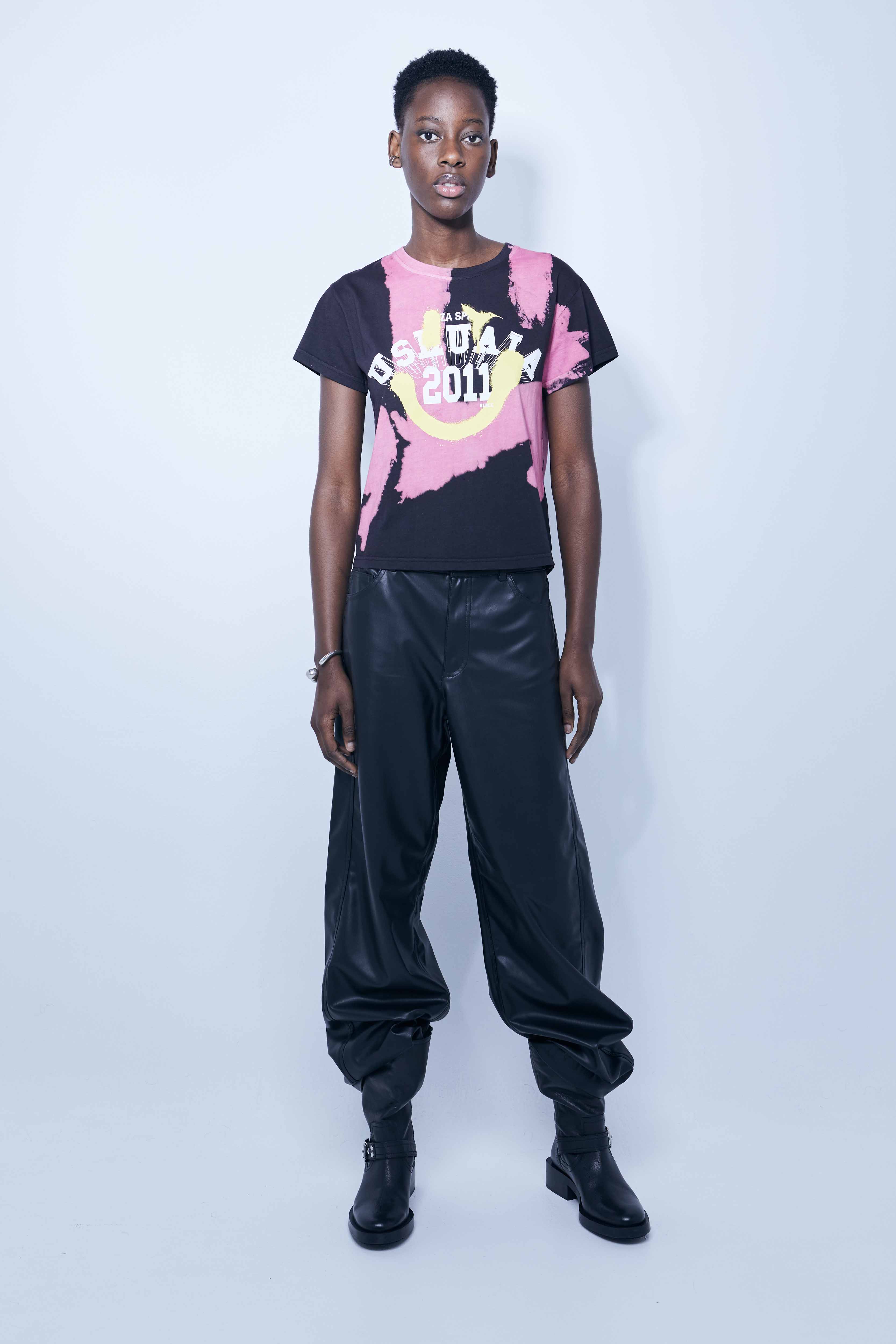 Pink tie-dye T-shirt with bold black logo print – Ushuaïa Ibiza streetwear essential.