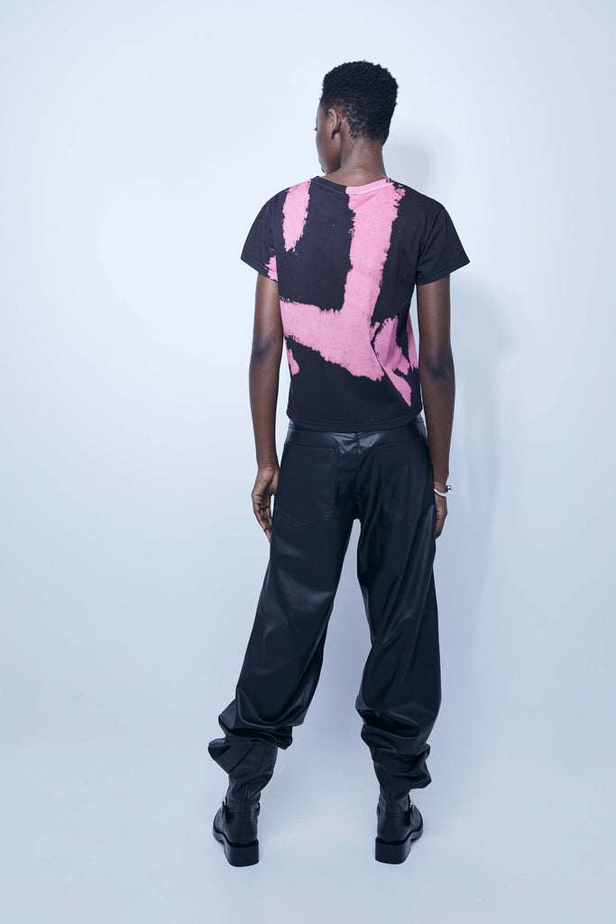 Pink tie-dye T-shirt with bold black logo print – Ushuaïa Ibiza streetwear essential.