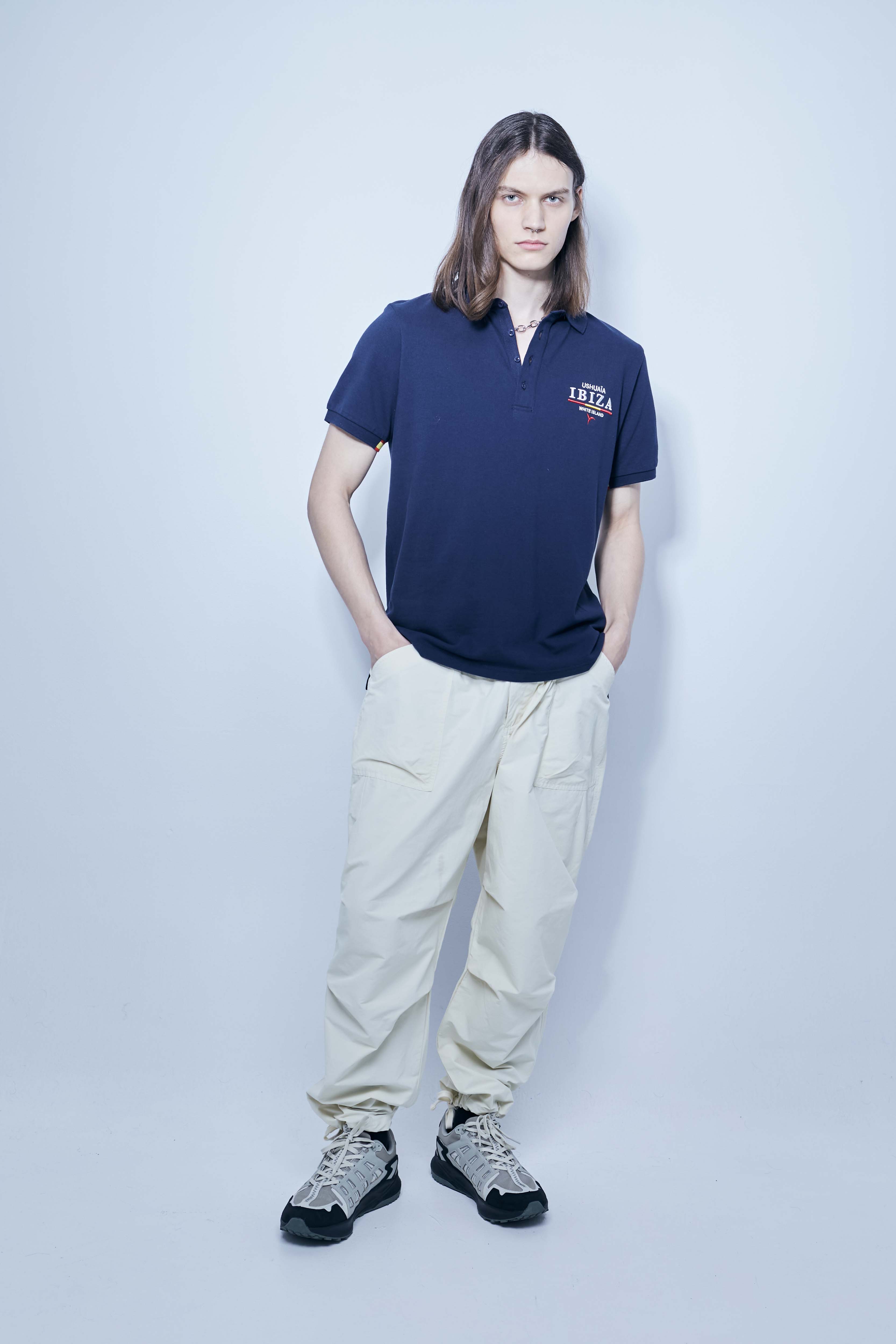 Polo made of cotton fabric with a mercerized finish. Lapel collar with front button closure and short sleeves. Embroidered application detail on the front