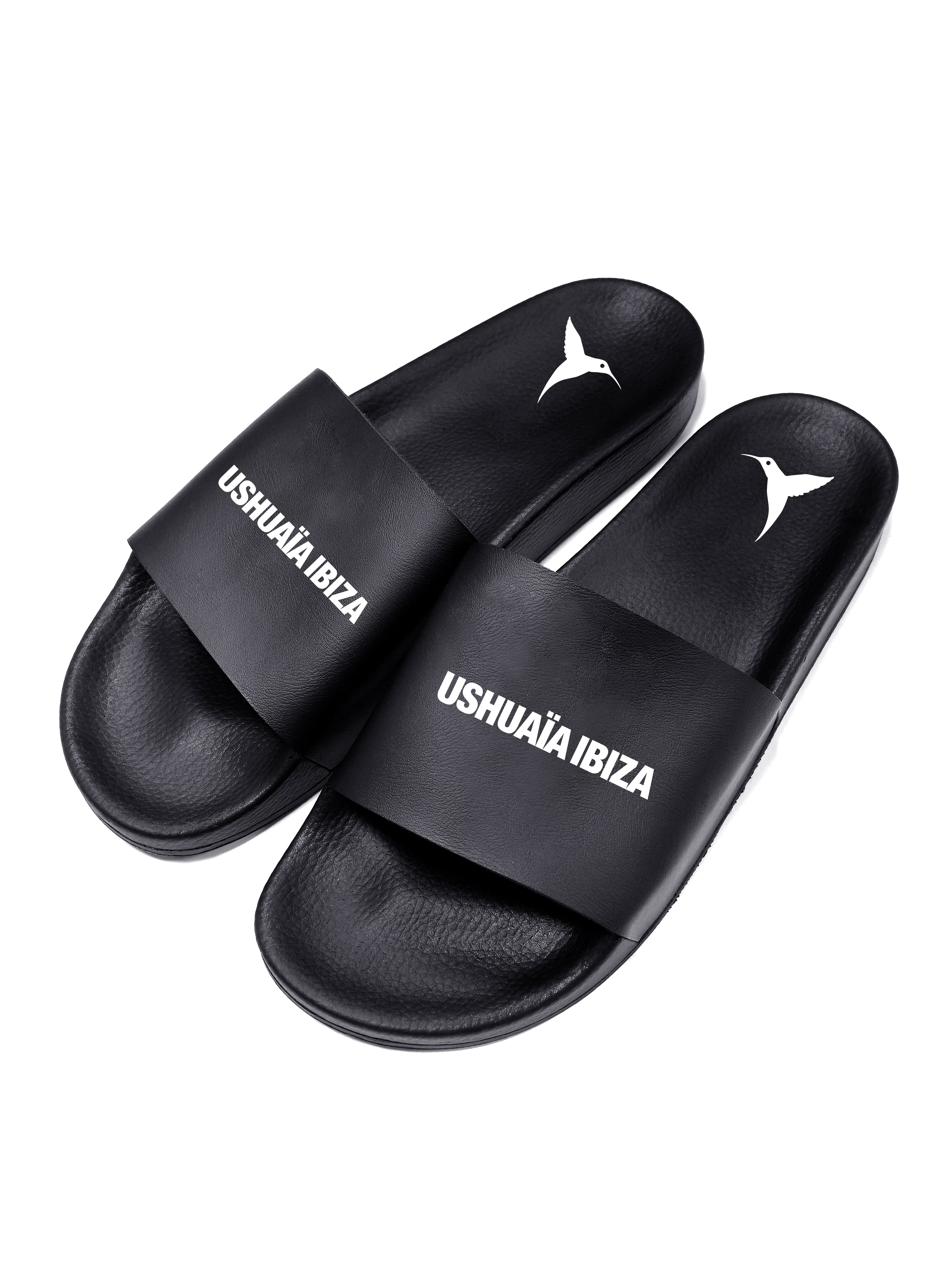 Black flip flops with white logo.Polyurethane sole with cotton and polyester lining.Screen printing and engraving in high frecuency.