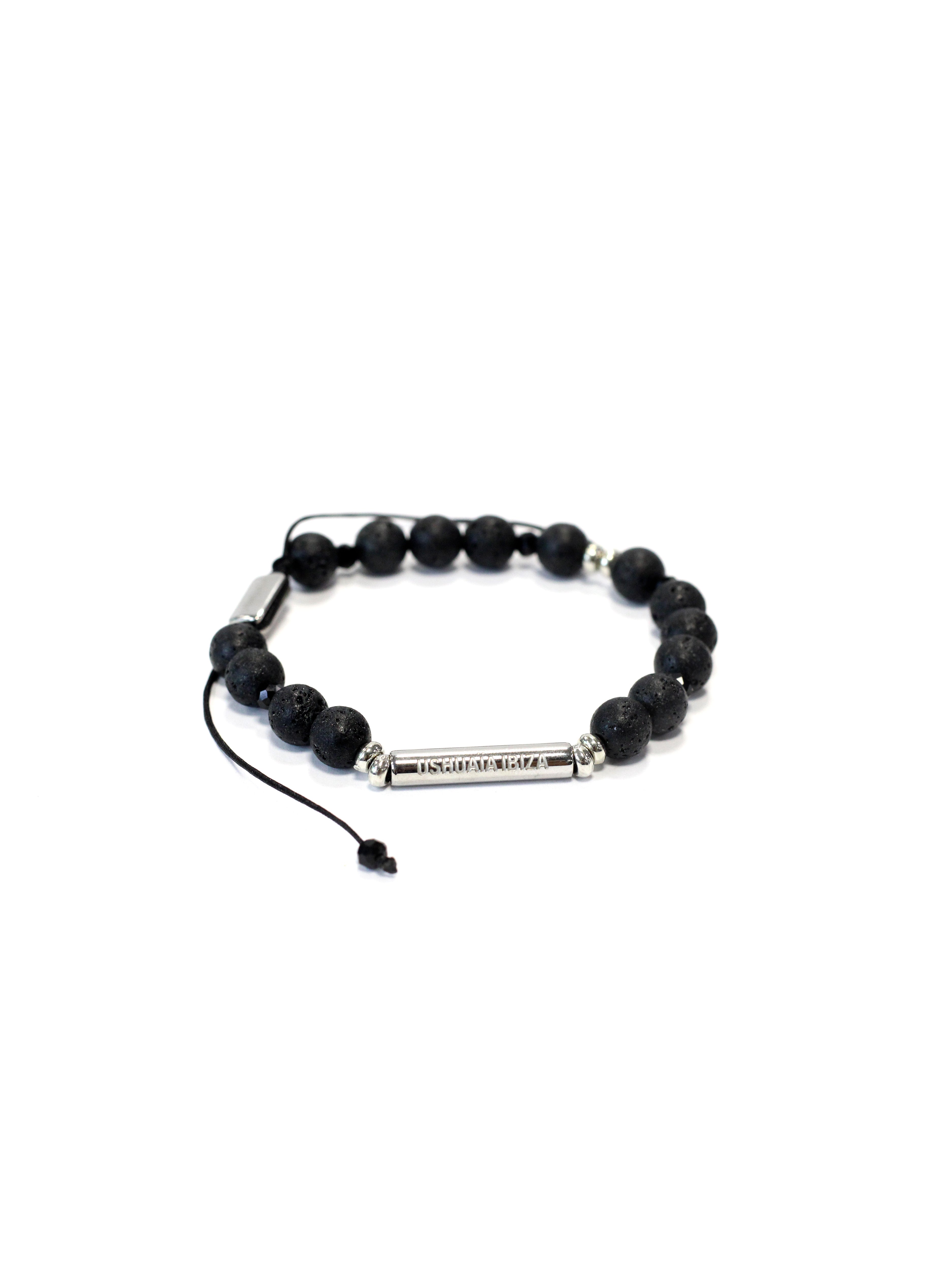 Adjustable bracelet with textile cord. Round black volcanic stone beads. Cylindrical metal plate engraved with Ushuaïa Ibiza logo. Unisex design.
COMPOSITION:
volcanic stone, metal alloy, textile cord.