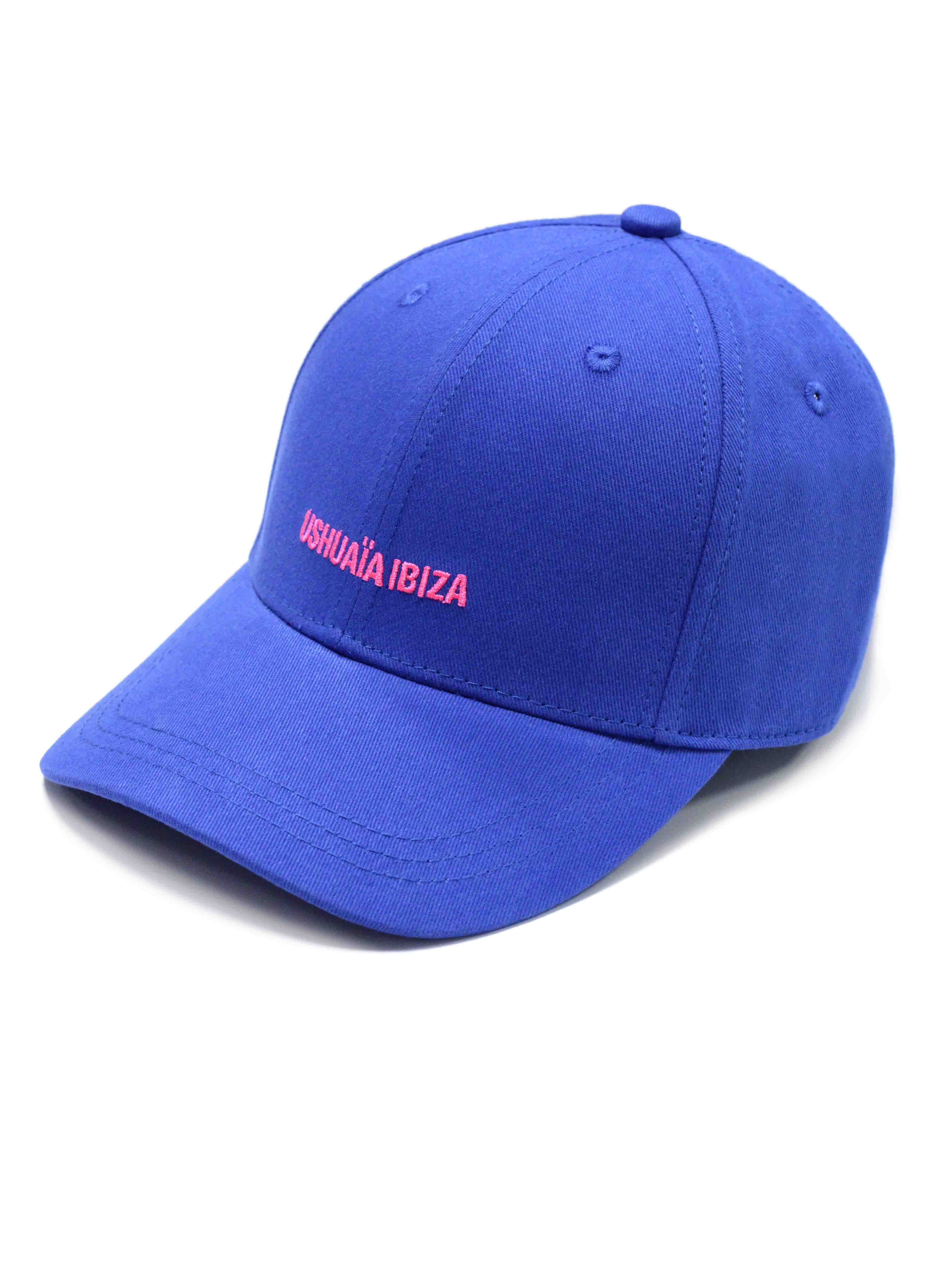 Curved visor cap in vibrant blue with contrasting pink Ushuaïa Ibiza rubber logo on the front. Adjustable back strap for a personalized fit.