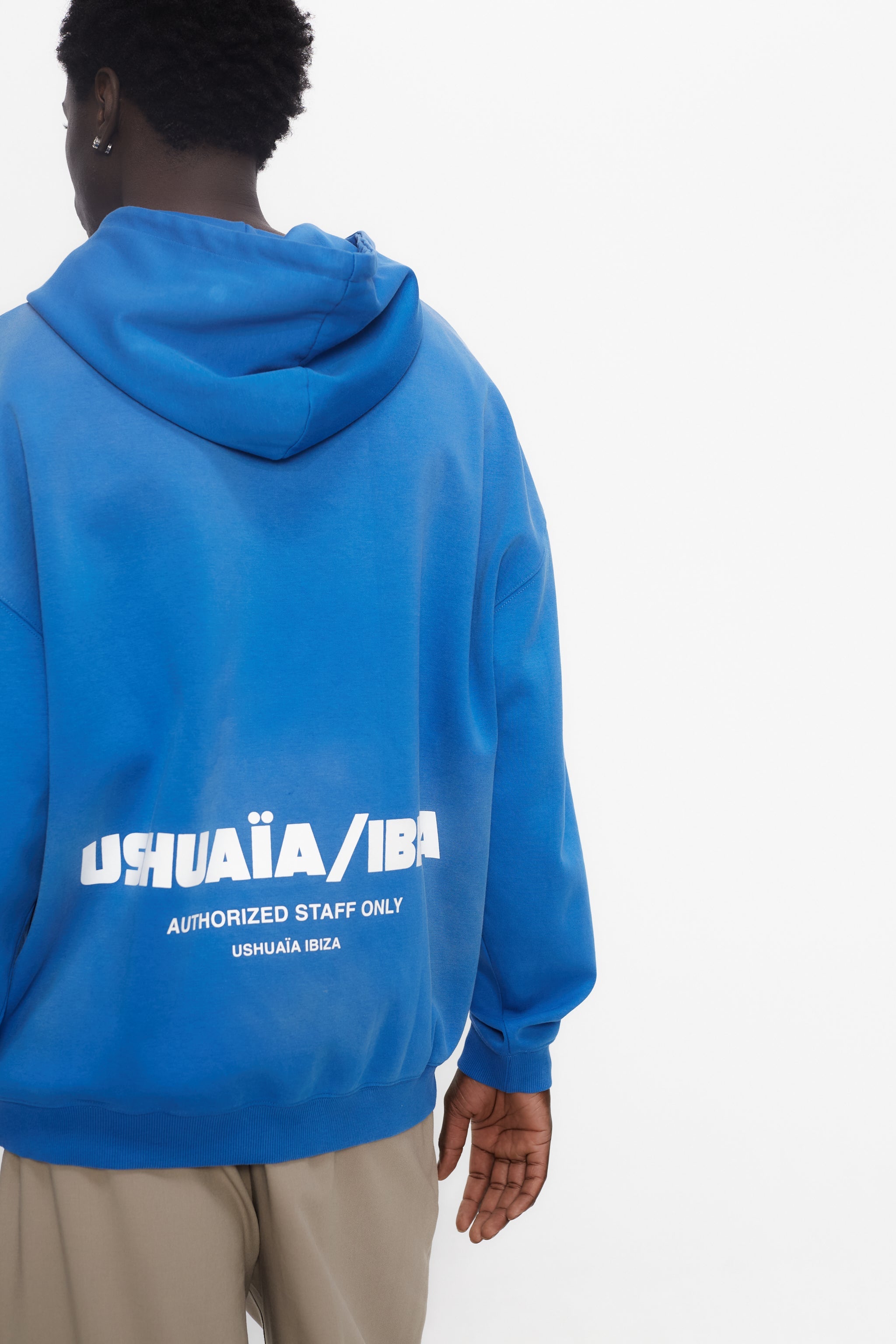 Oversized sweatshirt with adjustable hood with drawstring and long sleeves washed with enzymatic effect. Contrast combined patch detail on the front and print on the back. Kangaroo pocket on the front. Ribbed finishes.  