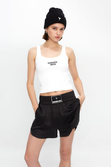 Rib tank top with round neck and armhole sleeve. Rubber effect print detail on the front. 