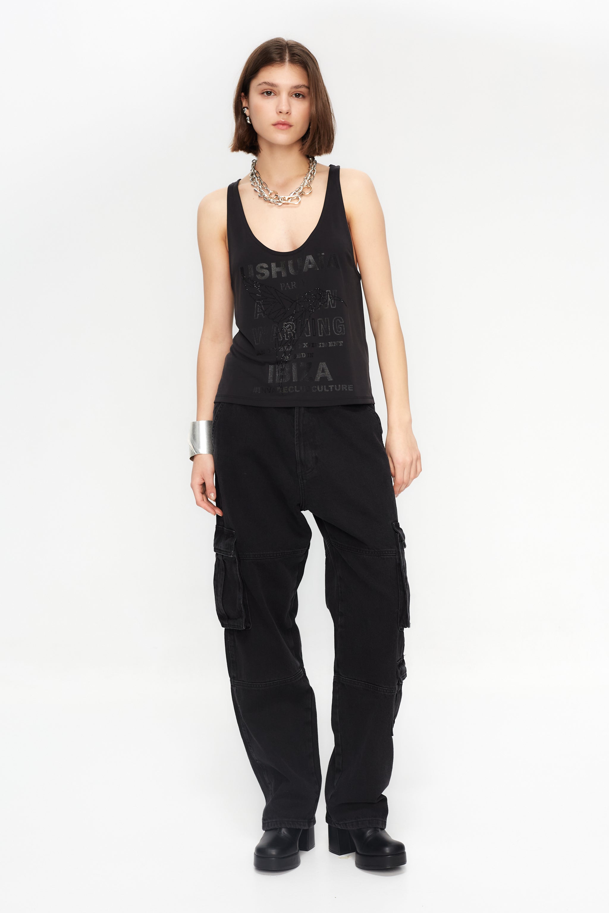 Black loose-fit tank with glitter effect & rhinestone details. Perfect for bold Ibiza looks. Shop your statement vibe now!