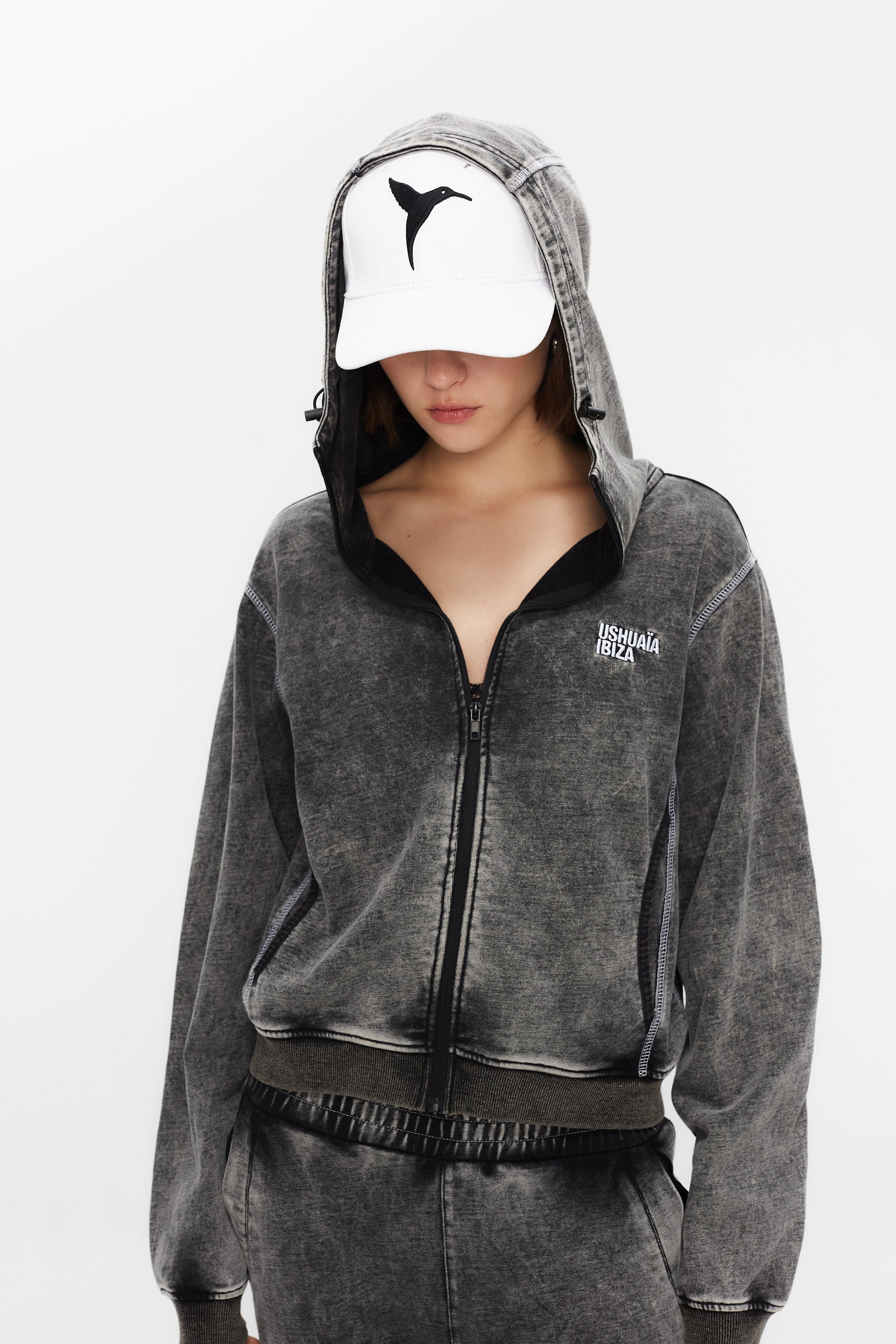 Hoodie with acid wash finish. Features a zipper running from sleeve to sleeve across the back, revealing a hidden print in white finish.