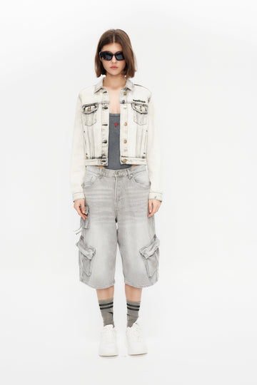 Model wearing women's cropped denim jacket acid wash by Ushuaïa with front embroidery.