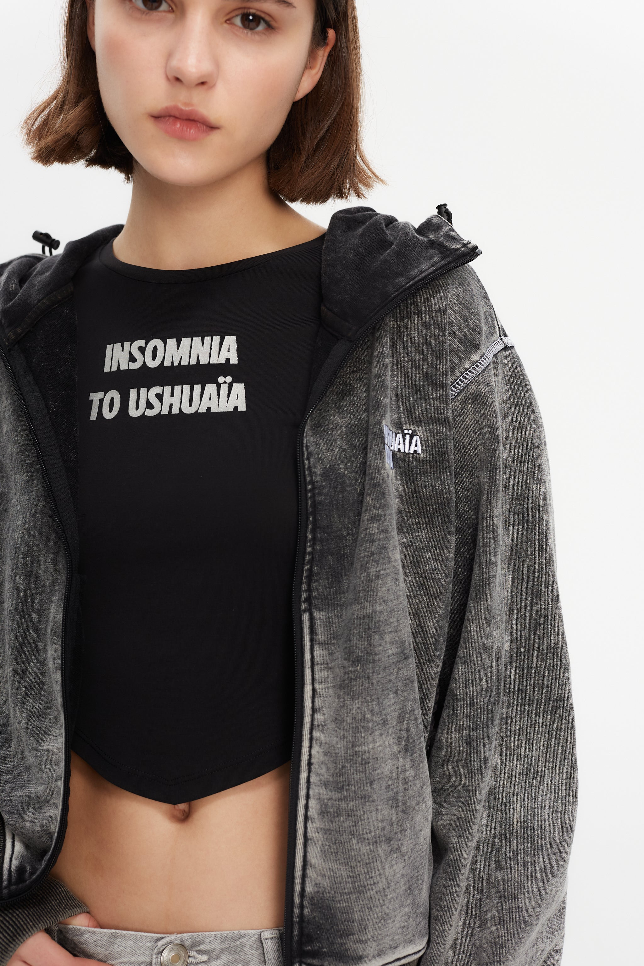 Hoodie with acid wash finish. Features a zipper running from sleeve to sleeve across the back, revealing a hidden print in white finish.