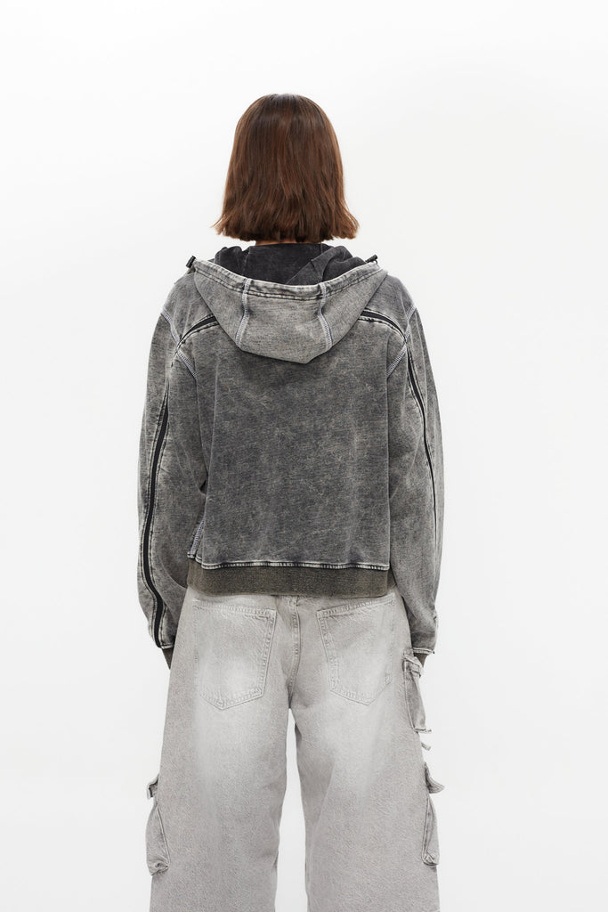 Hoodie with acid wash finish. Features a zipper running from sleeve to sleeve across the back, revealing a hidden print in white finish.