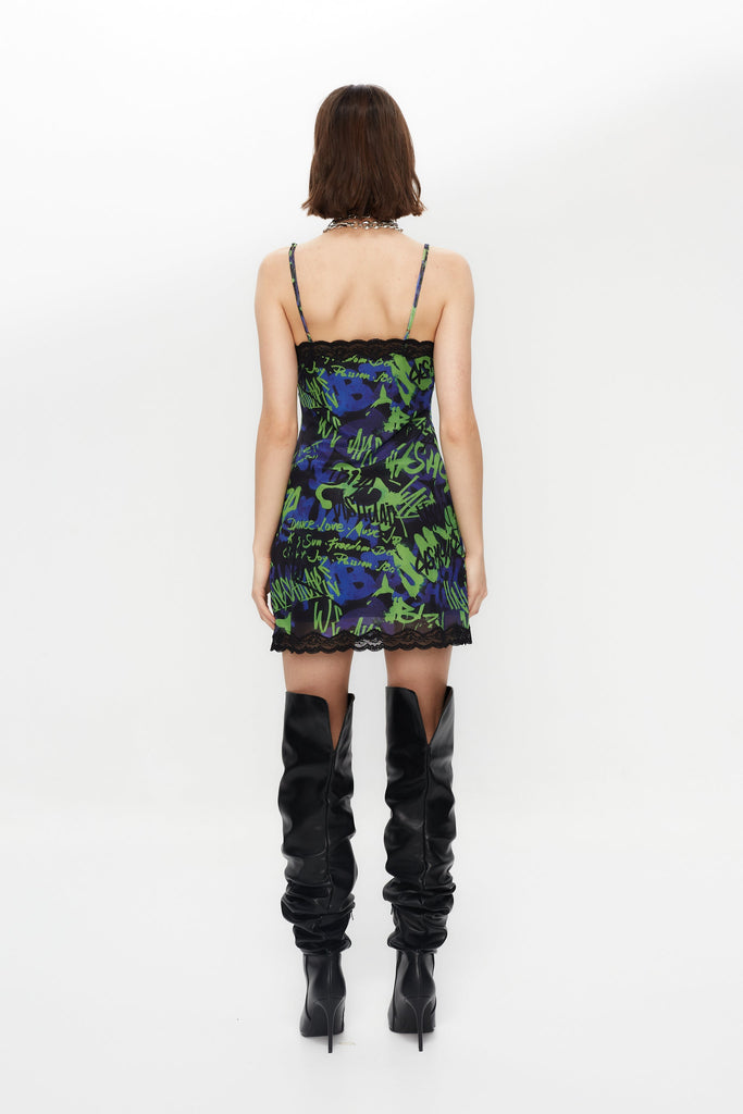 Elastic printed lingerie dress with lining. Adjustable straps. Lace and bow detail with metallic ornament on neckline and hem opening. 