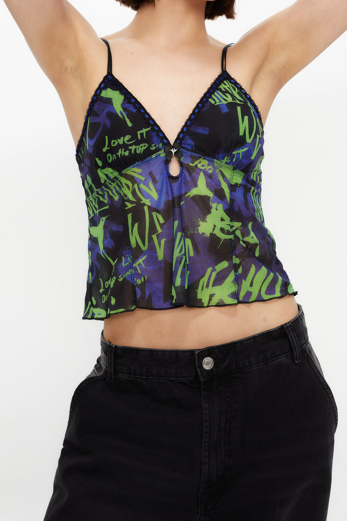 Printed lingerie tank top with adjustable straps. Bow detail with metallic ornament.