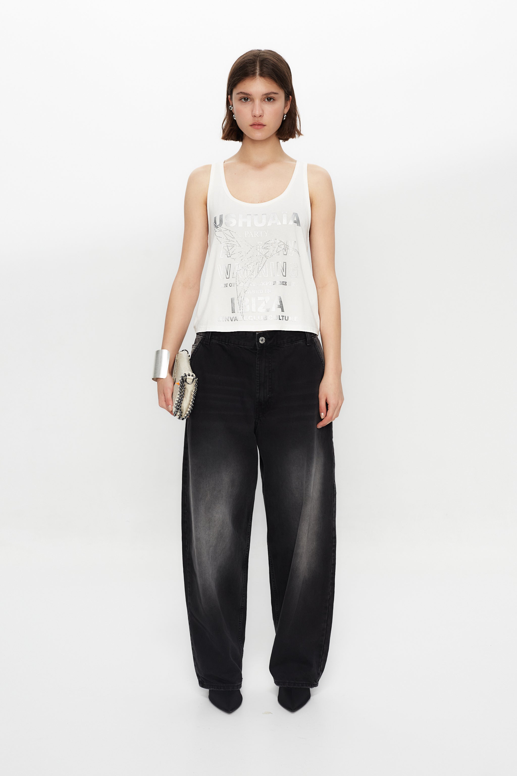 Tank top with round neck and armhole sleeves. Contrast metallic print combined with rhinestones on the front. Stitching detail on the back.
 