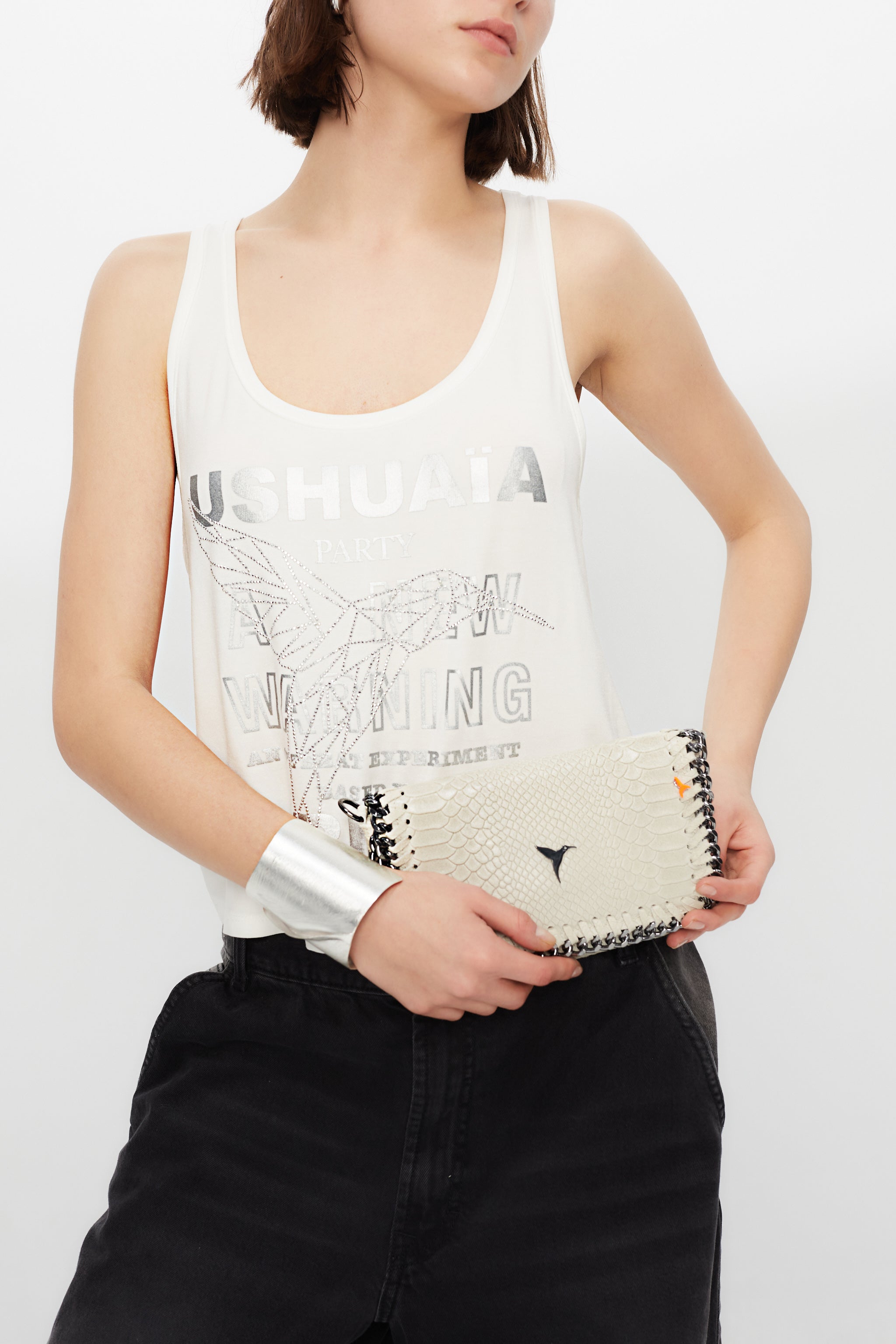 Tank top with round neck and armhole sleeves. Contrast metallic print combined with rhinestones on the front. Stitching detail on the back.
 