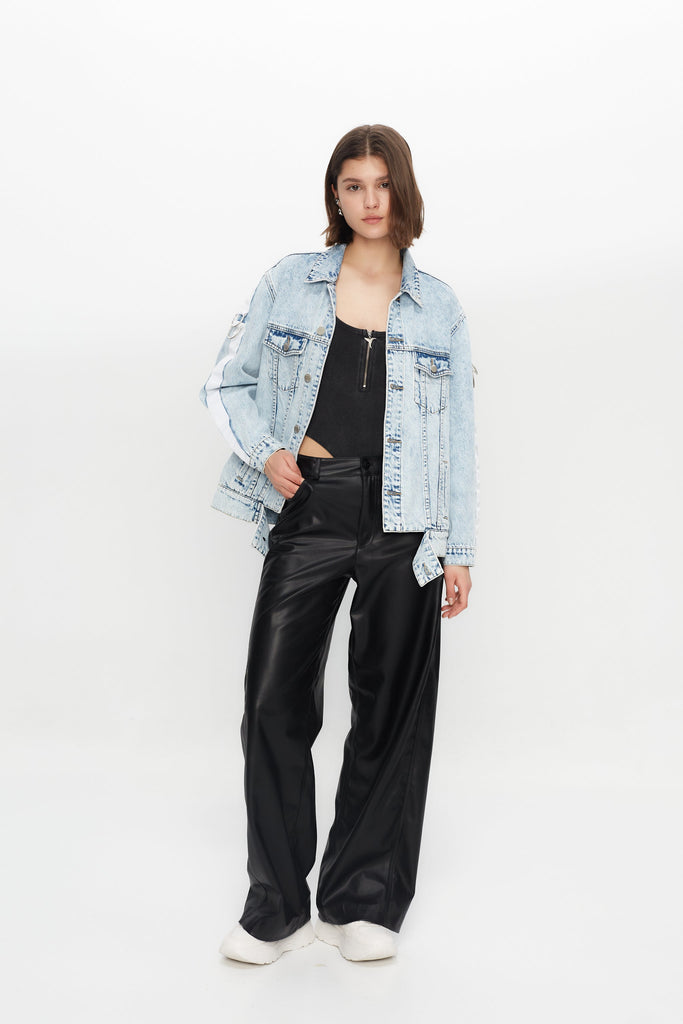 Denim jacket with a back panel featuring an appliqué with applied text and embroidery. Side sleeve panel embroidered with silver eyelet finish.